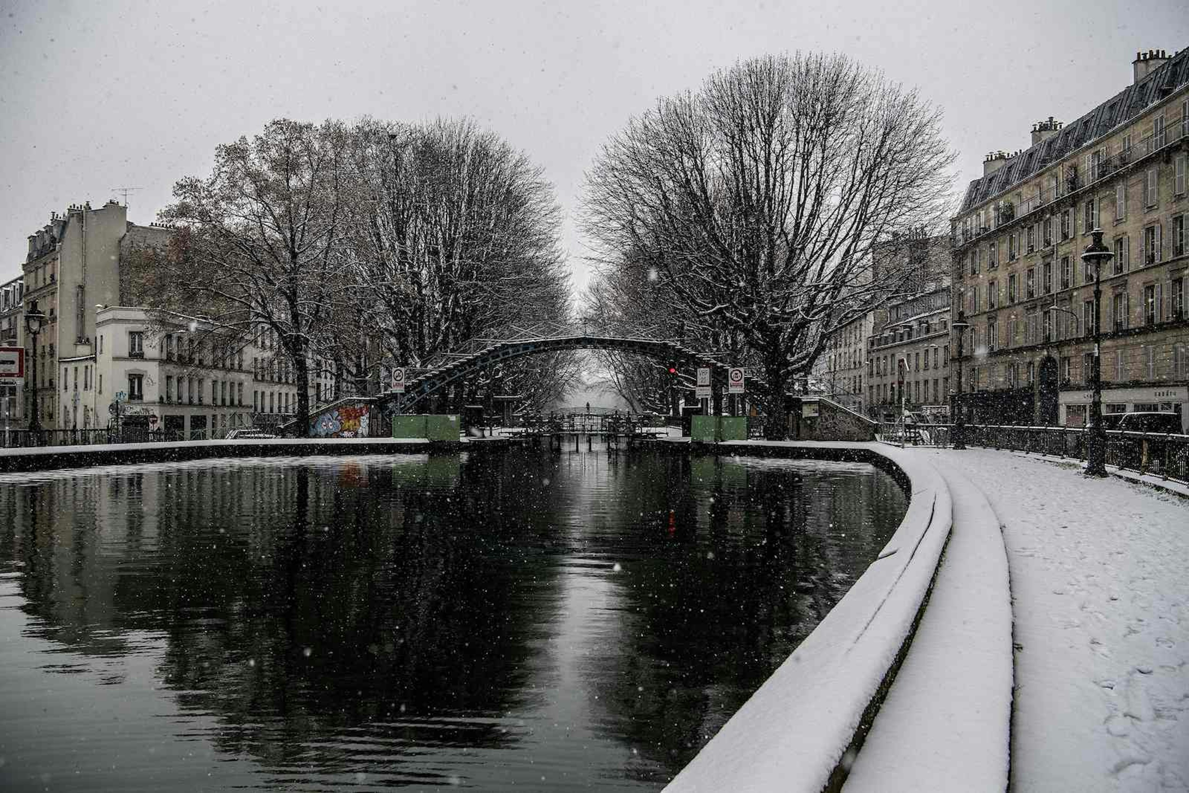 Snow falls over the canal Saint-Martin in Paris on January 22, 2019.