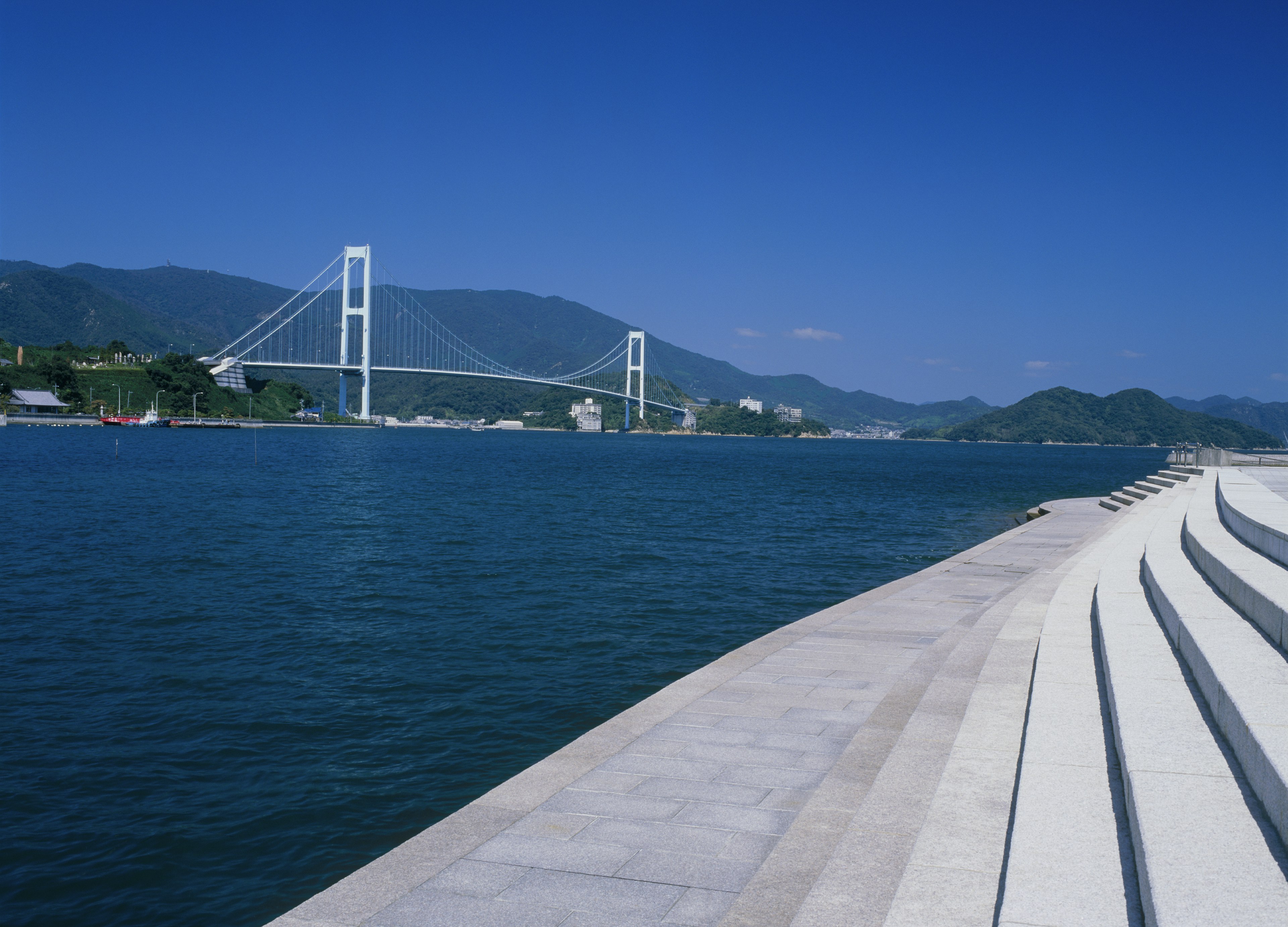 The Akinaada Bridge is a white suspension bridge