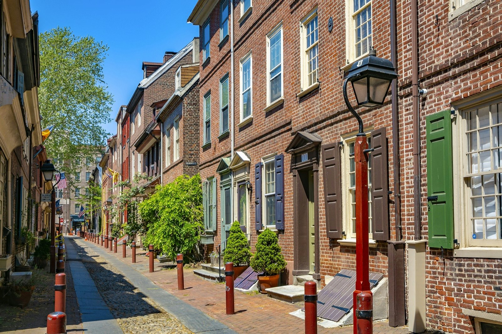 Historic brick homes line the narrow Elfreth's Alley in Philadelphia. Lafayette in the Somewhat United States is a fantastic selection for audiobooks for US road trip.