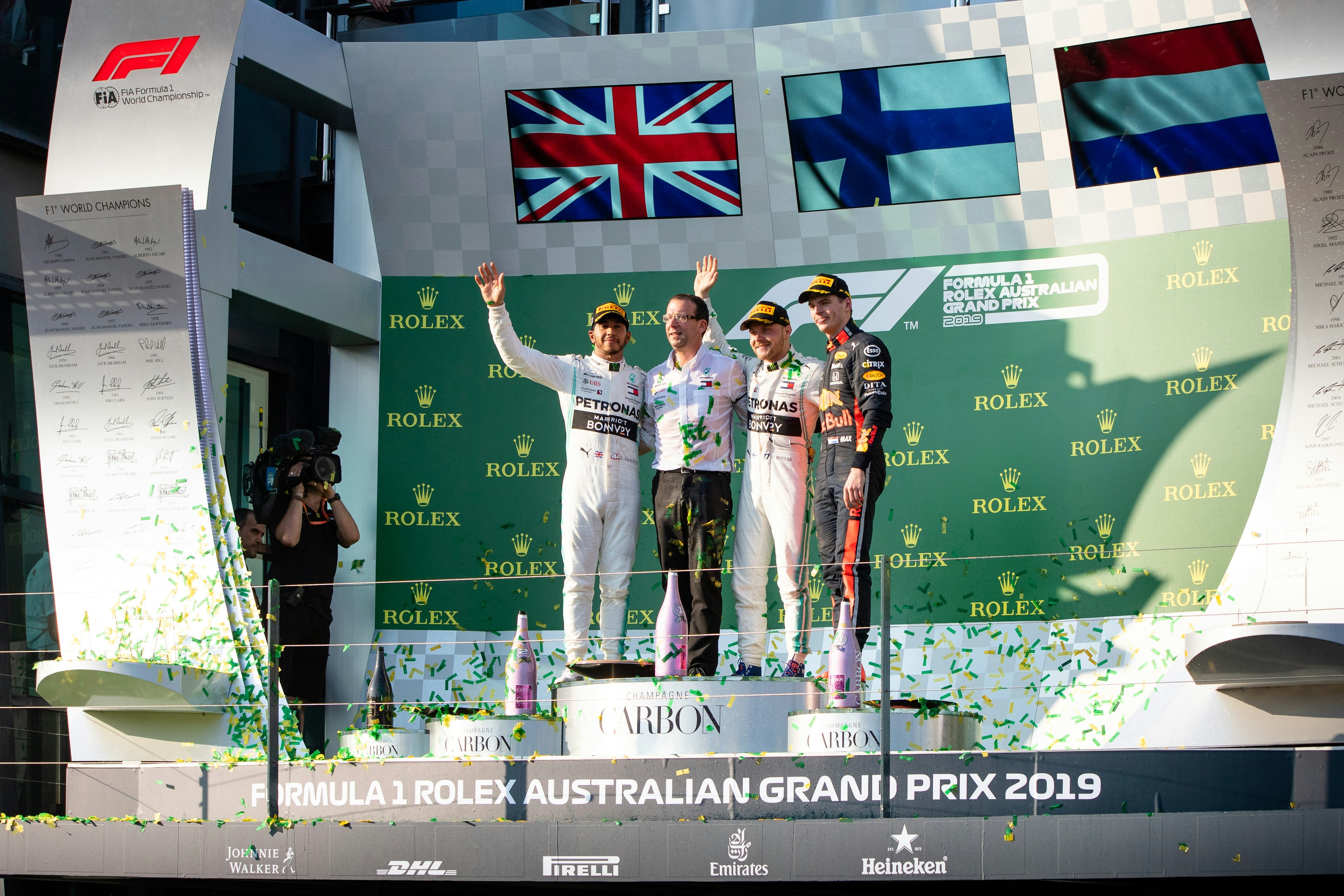 L-R Second place Mercedes-AMG Petronas Motorsport driver Lewis Hamilton (44), Mercedes Head of Vehicle Dynamics Loic Serra, winner Mercedes-AMG Petronas Motorsport driver Valtteri Bottas (77) and Aston Martin Red Bull Racing driver Max Verstappen (33) on the podium at The Australian Formula One Grand Prix on March 17, 2019, at The Melbourne Grand Prix Circuit in Albert Park, Australia. (Photo by Speed Media/Icon Sportswire via Getty Images)