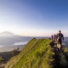 Hiking around the crater of Mount Batur with Mount Agung in the background
1133517872
sunrise - dawn, landscape - scenery, volcano, mountain, travel, nature, scenics - nature, sky, lake, famous place, morning, outdoors, asia, sunset, travel destinations, beauty in nature, volcanic landscape, beauty, tranquil scene, gunung batur, lake batur, mt agung, sun, silhouette, natural phenomenon, natural disaster, erupting, volcanic crater, hiking, adventure, lifestyles, backpacker, healthy lifestyle, exploration, freedom, cloud - sky, one person, walking, tourist, mountain peak, looking at view, geology, journey, backpack
Hiking around the crater of Mount Batur with Mount Agung in the background