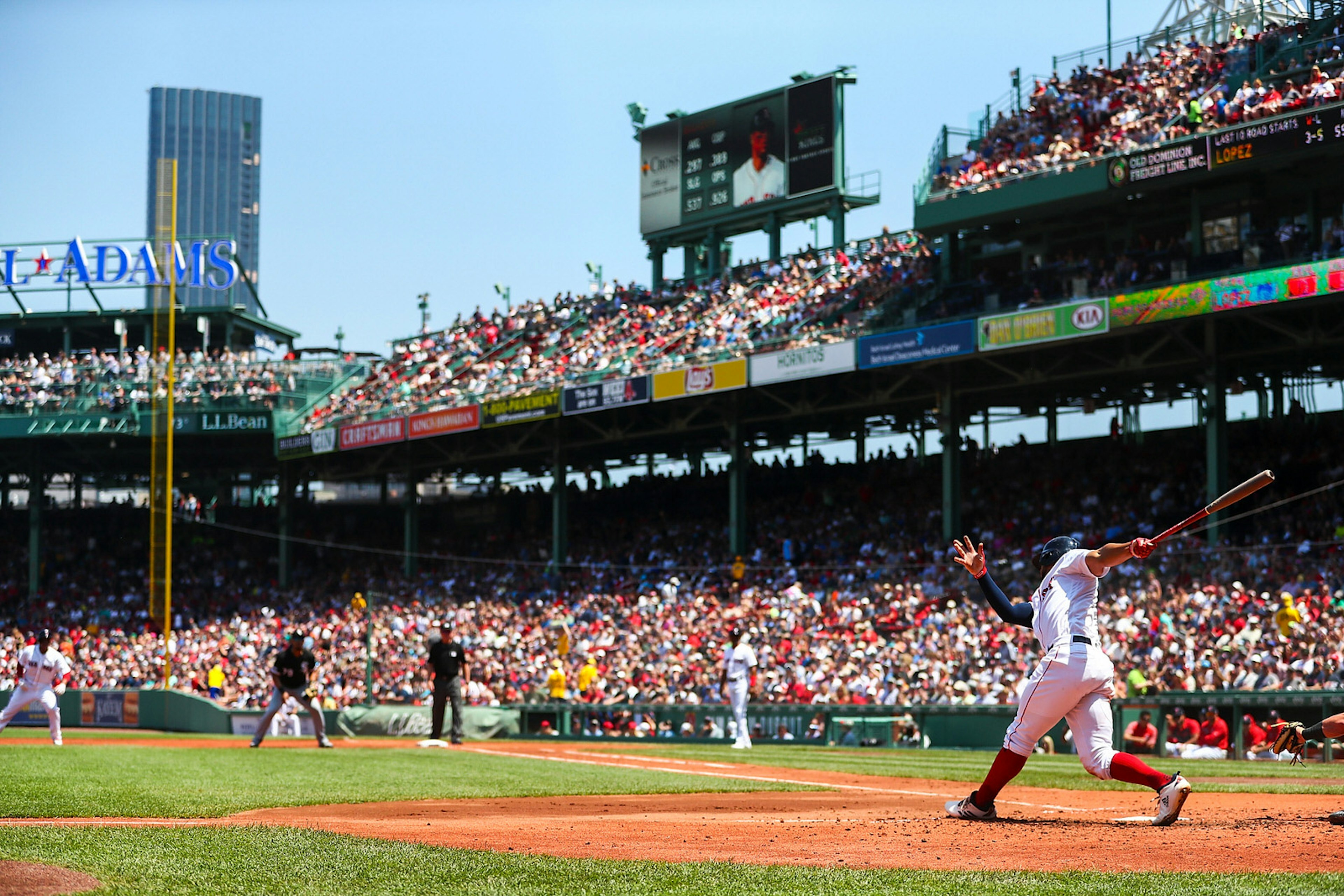 Xander Bogaerts #2 of the Boston Red Sox bats during a game against the Chicago White Sox at Fenway Park, with colourful crowds of people watching on. Rivalries in sport