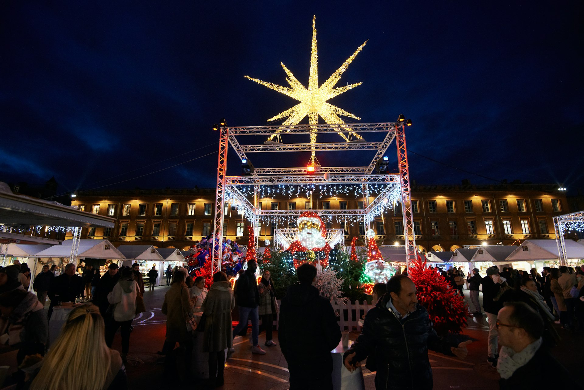 Festive lights and vendors at the Christmas market at the Place du Capitole, Toulouse