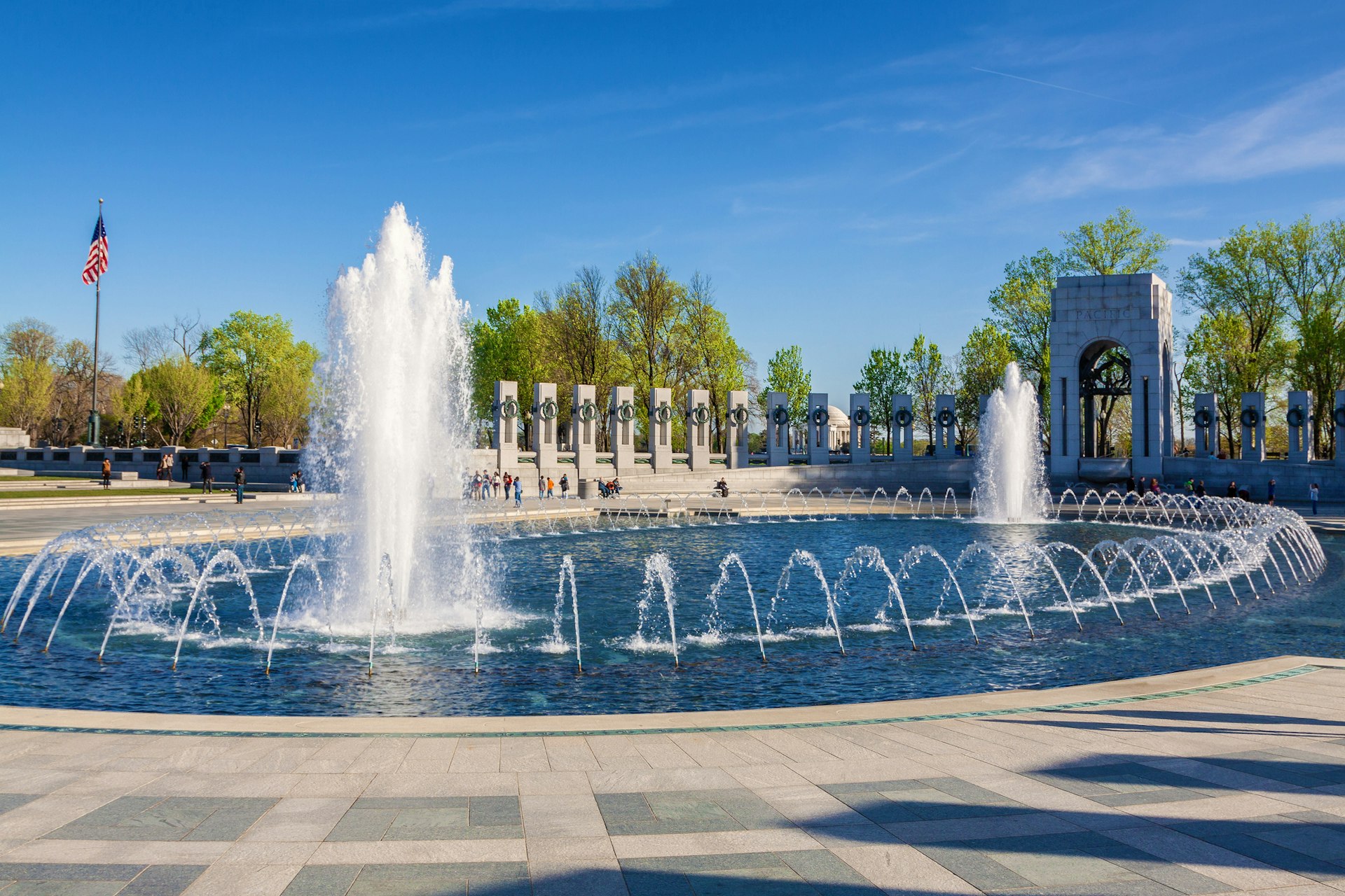 A massive fountain with spouting jets surrounded by cenotaphs