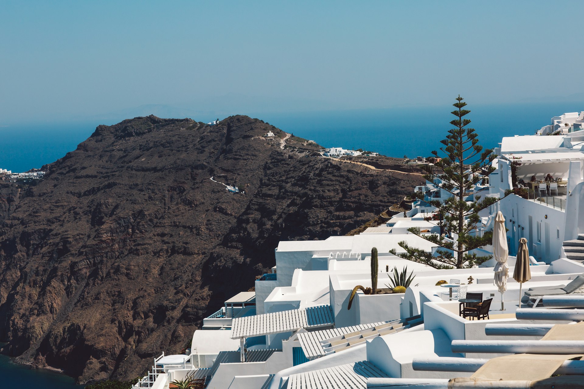 White houses and mountain scenery in the winter months against a blue sky in Merovigli, Santorini Greece