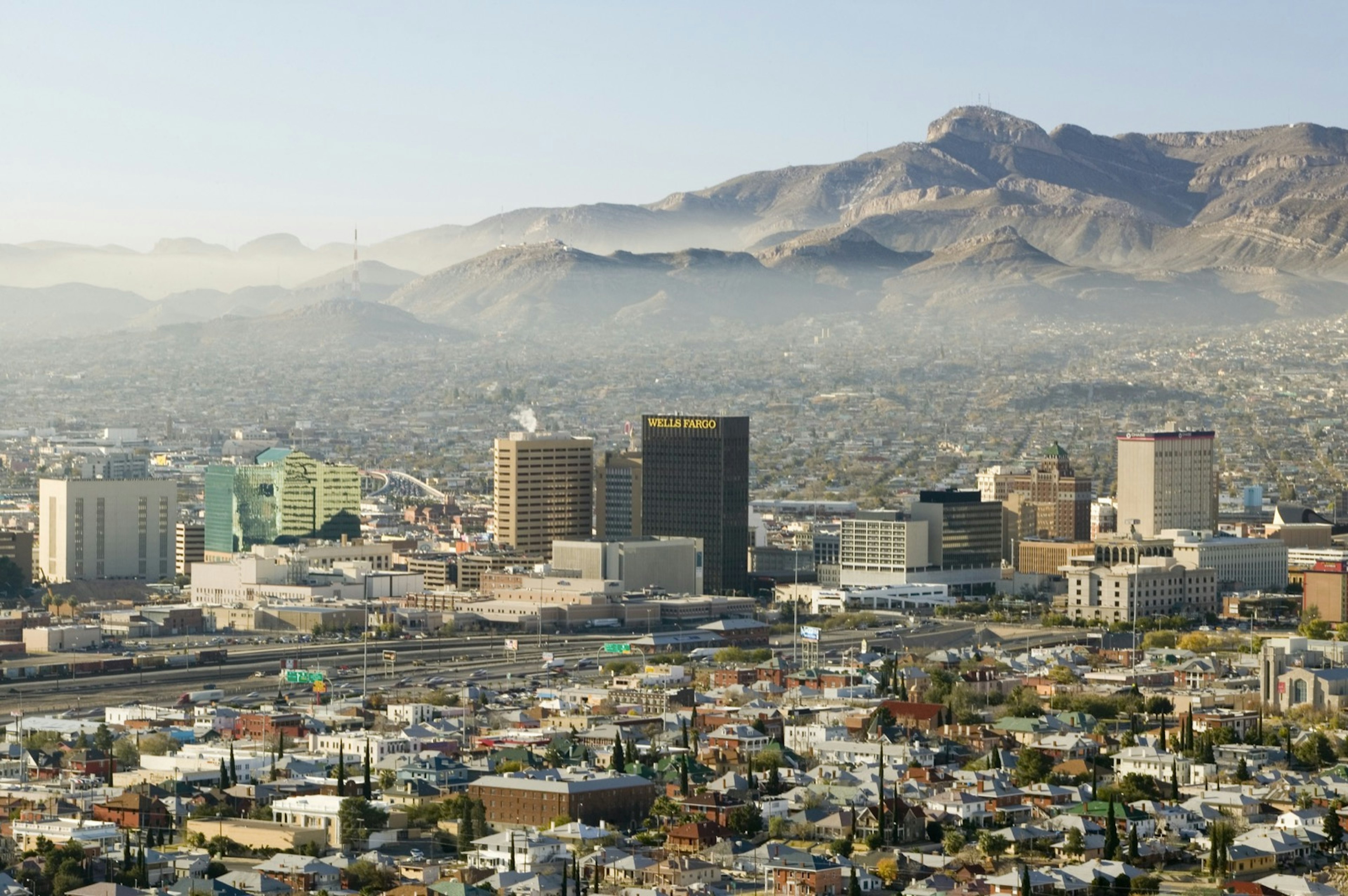 A misty haze hangs over the skyline of downtown El Paso, Texas, looking across the Mexico border toward Juarez