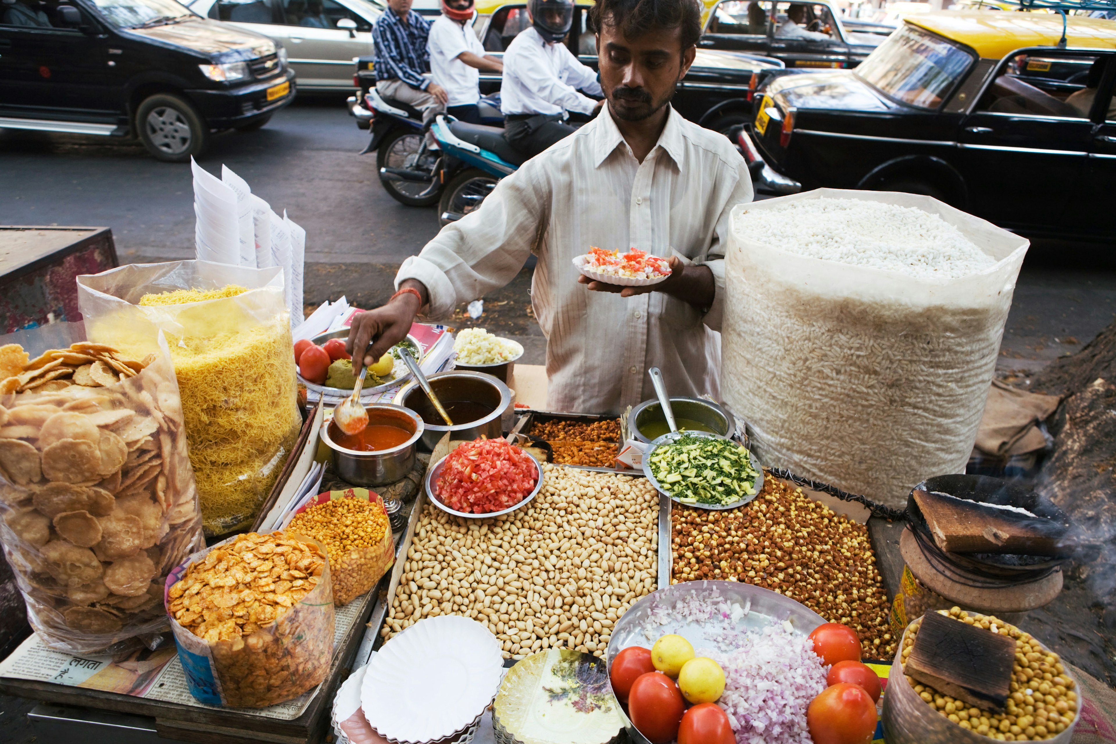 A vendor mixing ingredients for bhelpuri (Mumbai-style salad)