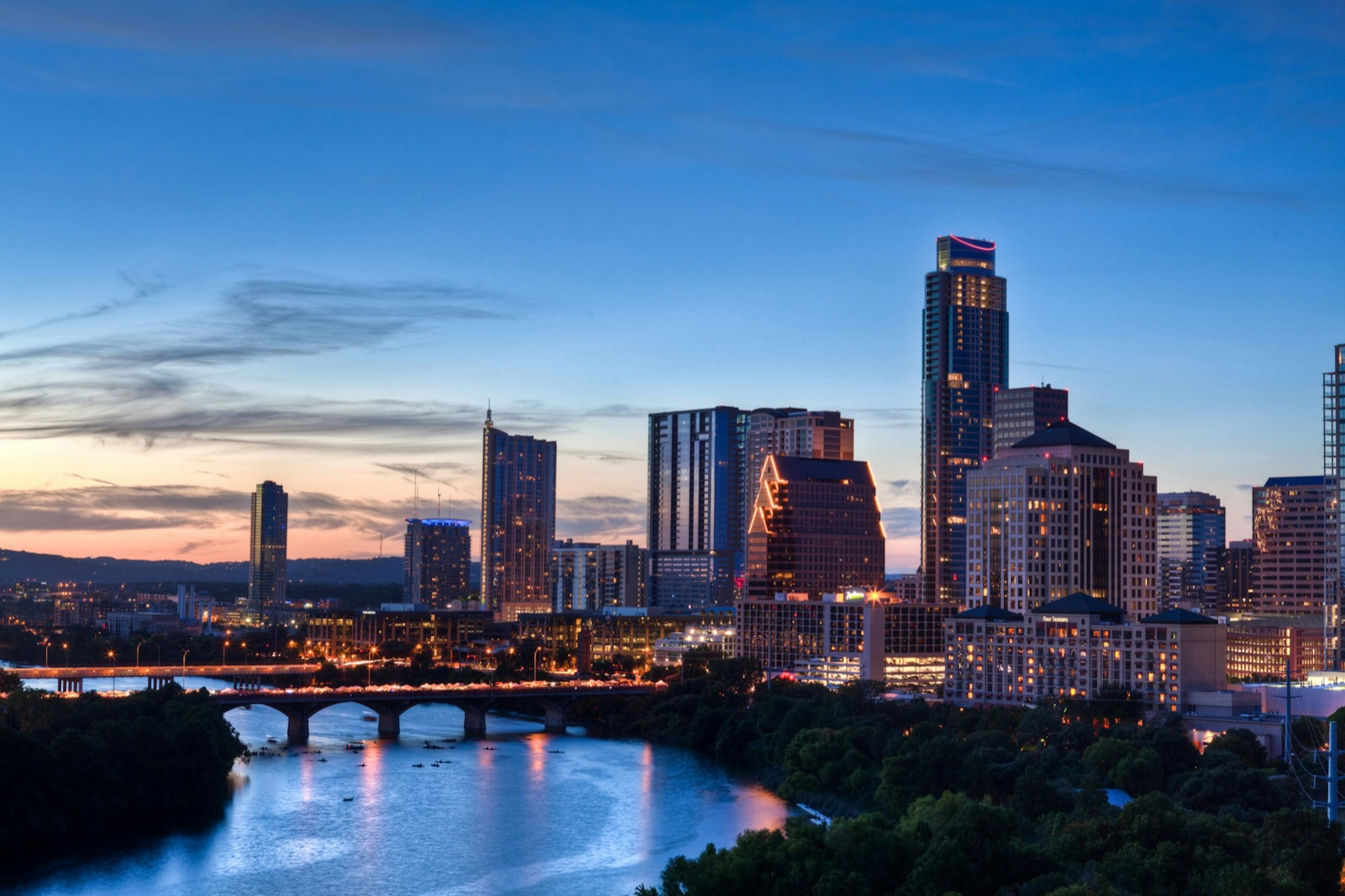 The South Congress bridge in Austin, Texas is lit up and packed with people.