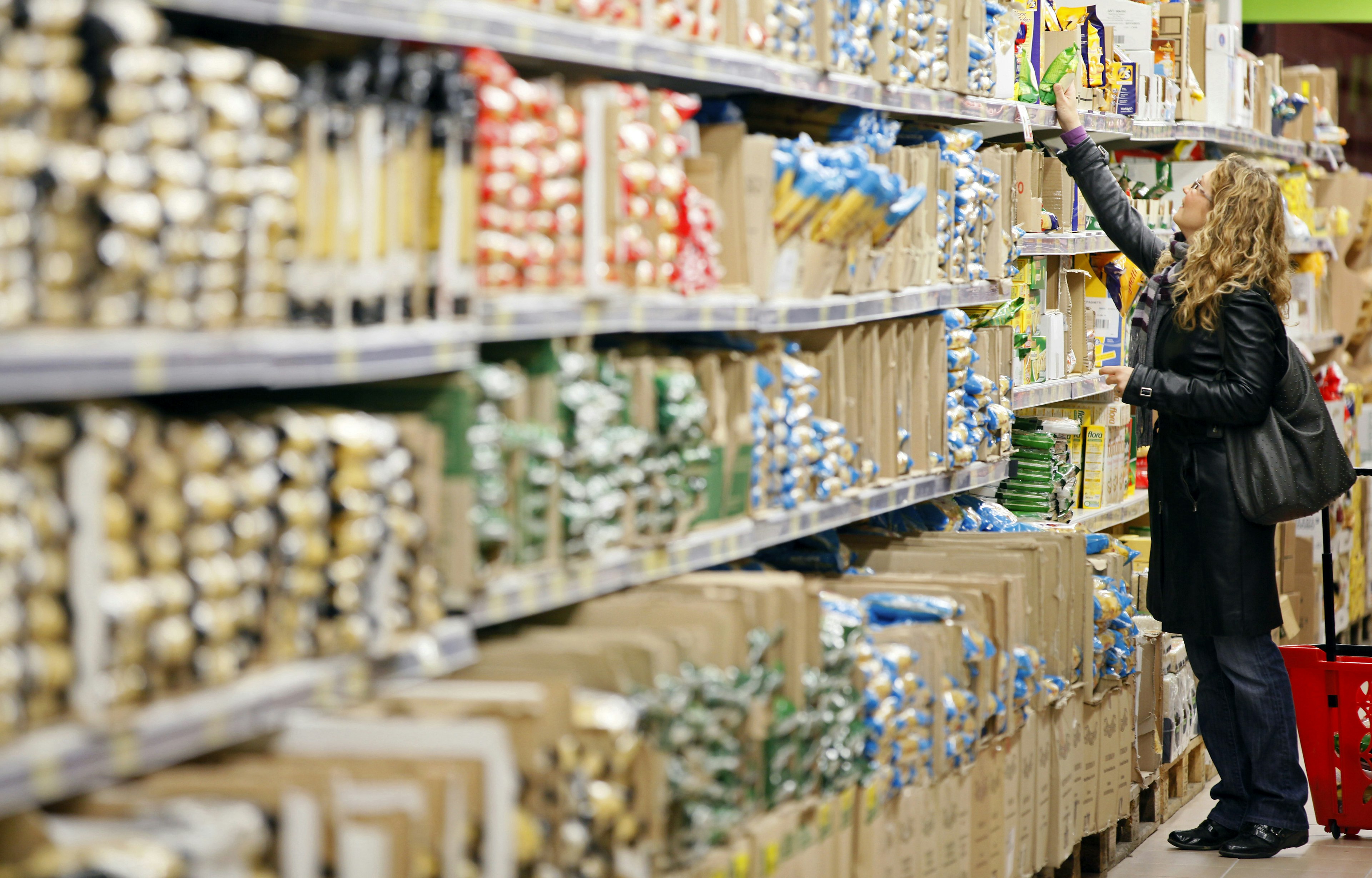 Woman shopping for pasta in Italian supermarket