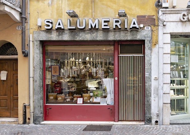 The shop window of an old-style salumeria (delicatessen) in central Mantua (Mantova), Italy