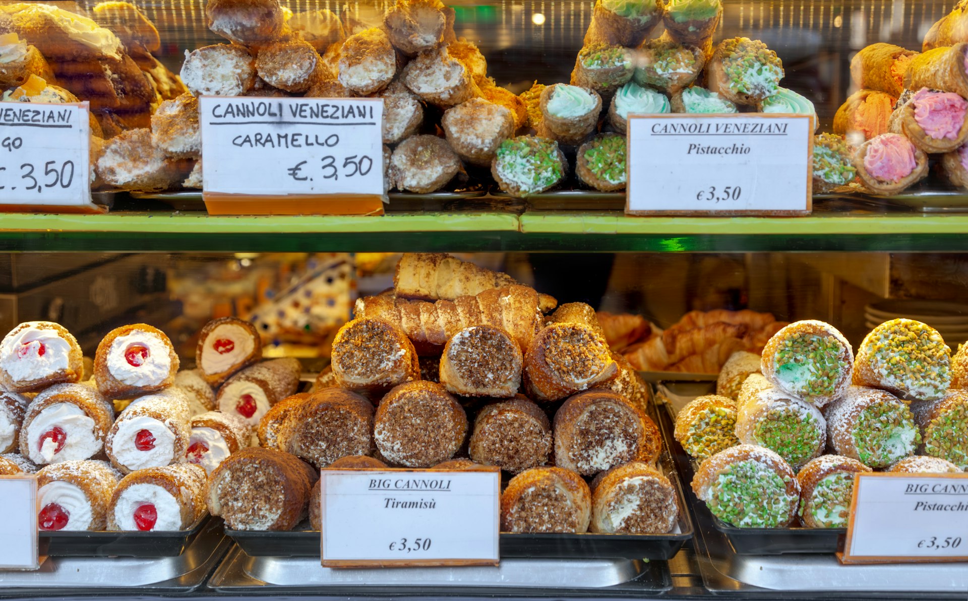 Cannoli and other pastries in the window of a pasticceria, Italy