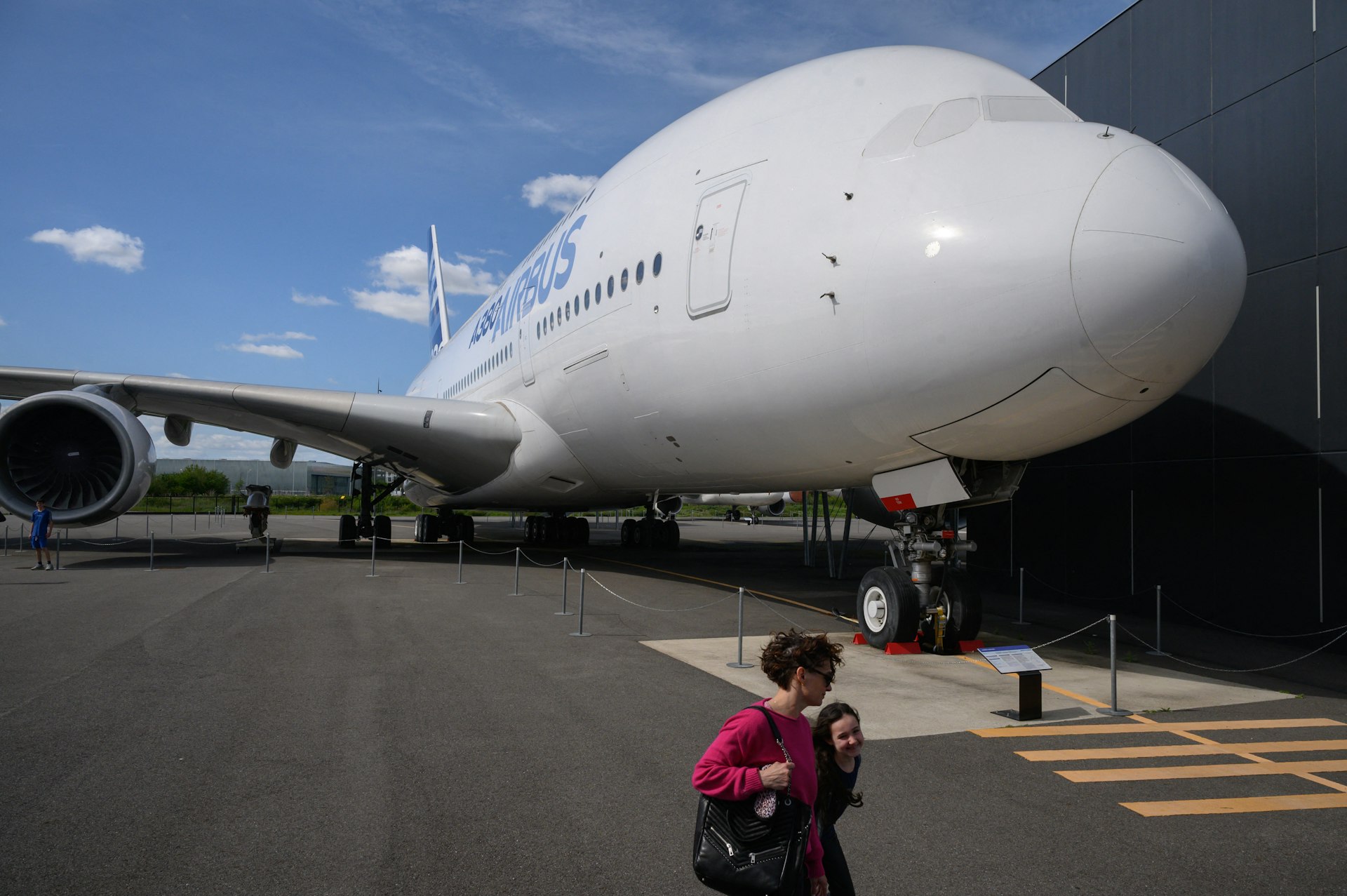 Visitors walk past an Airbus A380 aircraft on display at the Aeroscopia aeronautical museum in Toulouse