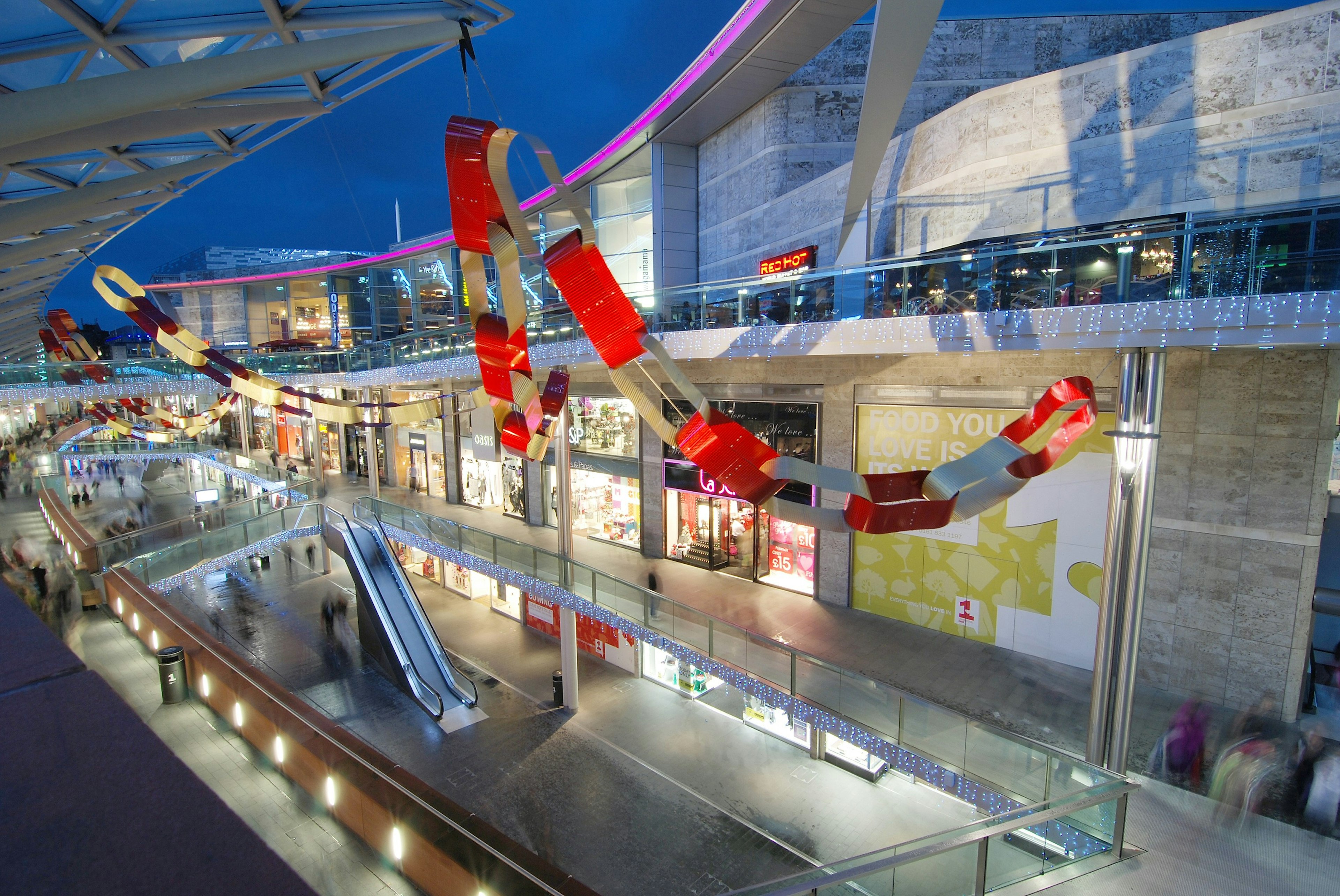 Liverpool ONE decorated for Christmas with giant read and white paper chains strewn across the mall.