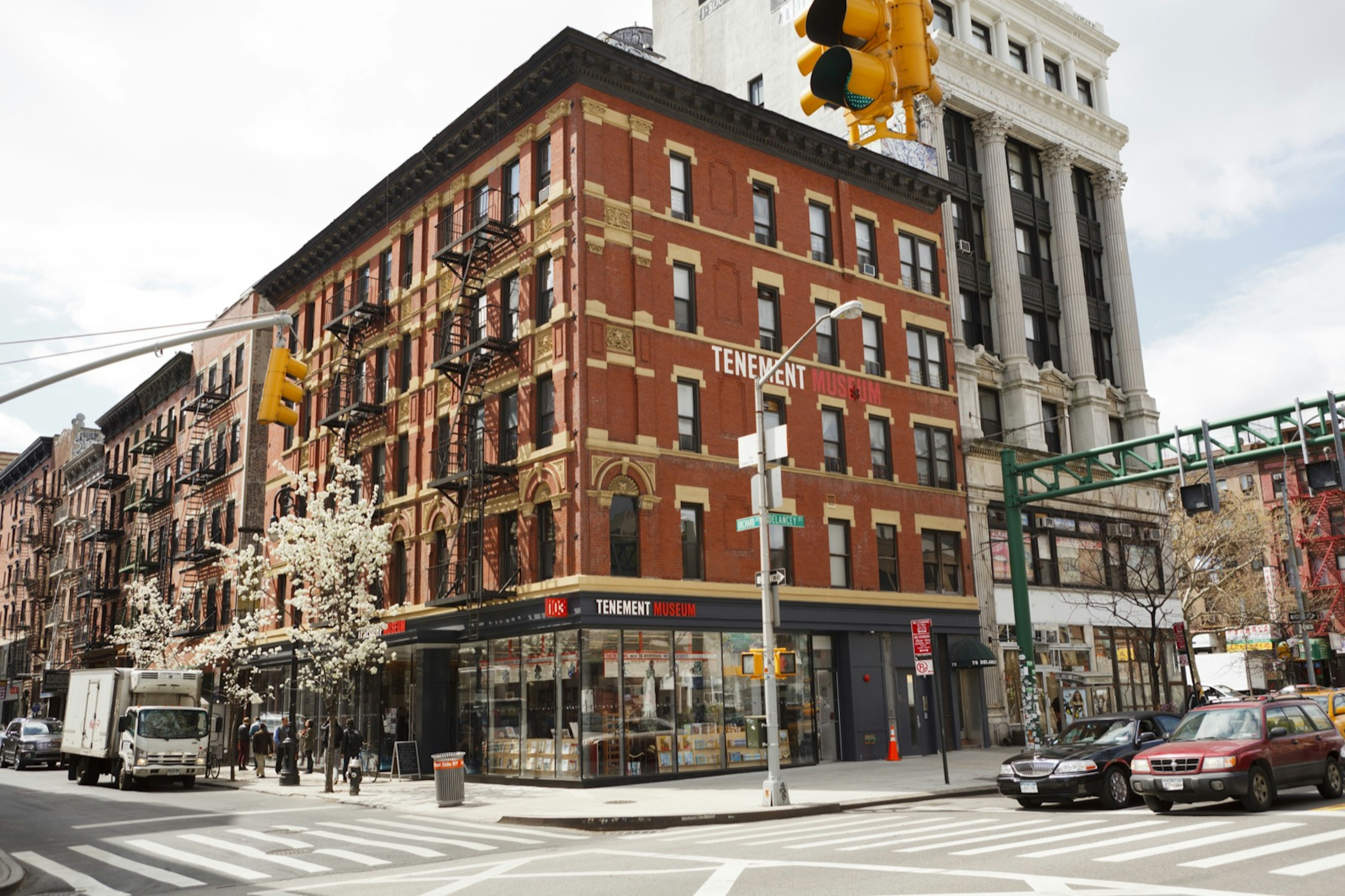 The brick facade of The Lower East Side Tenement Museum; a New York City Museum; the street in front