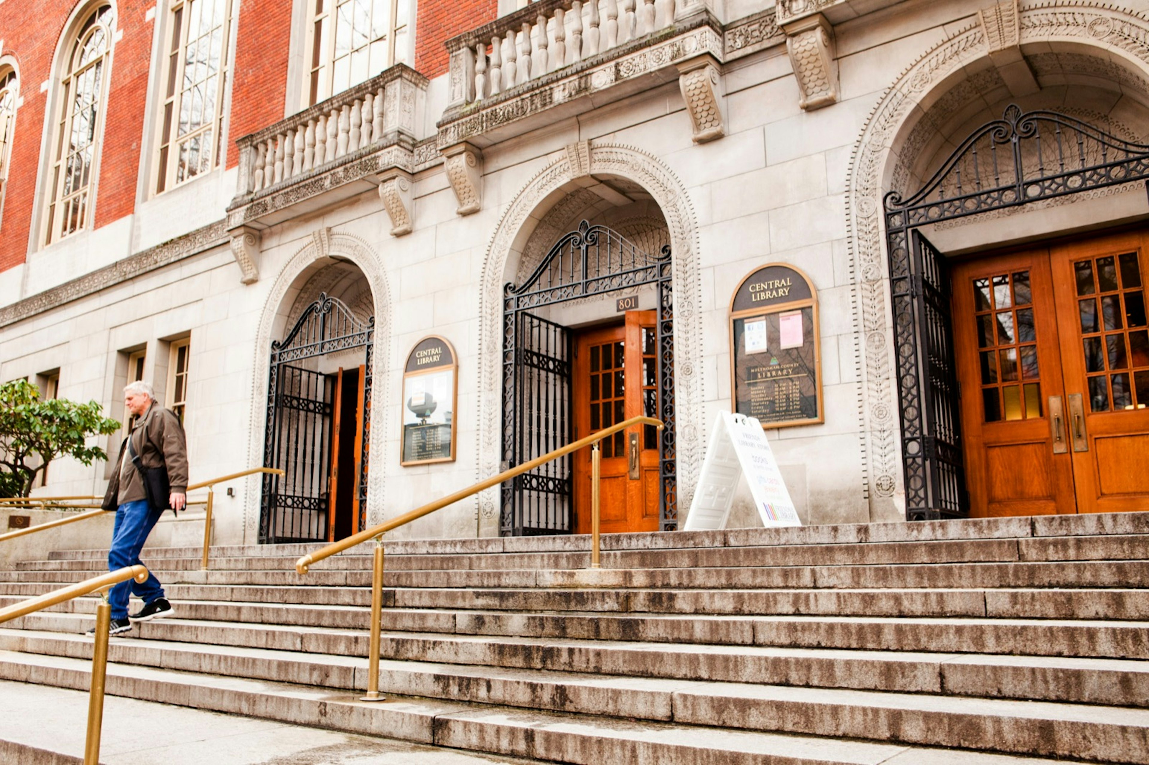 A man walks out of the Central Library in downtown Portland.