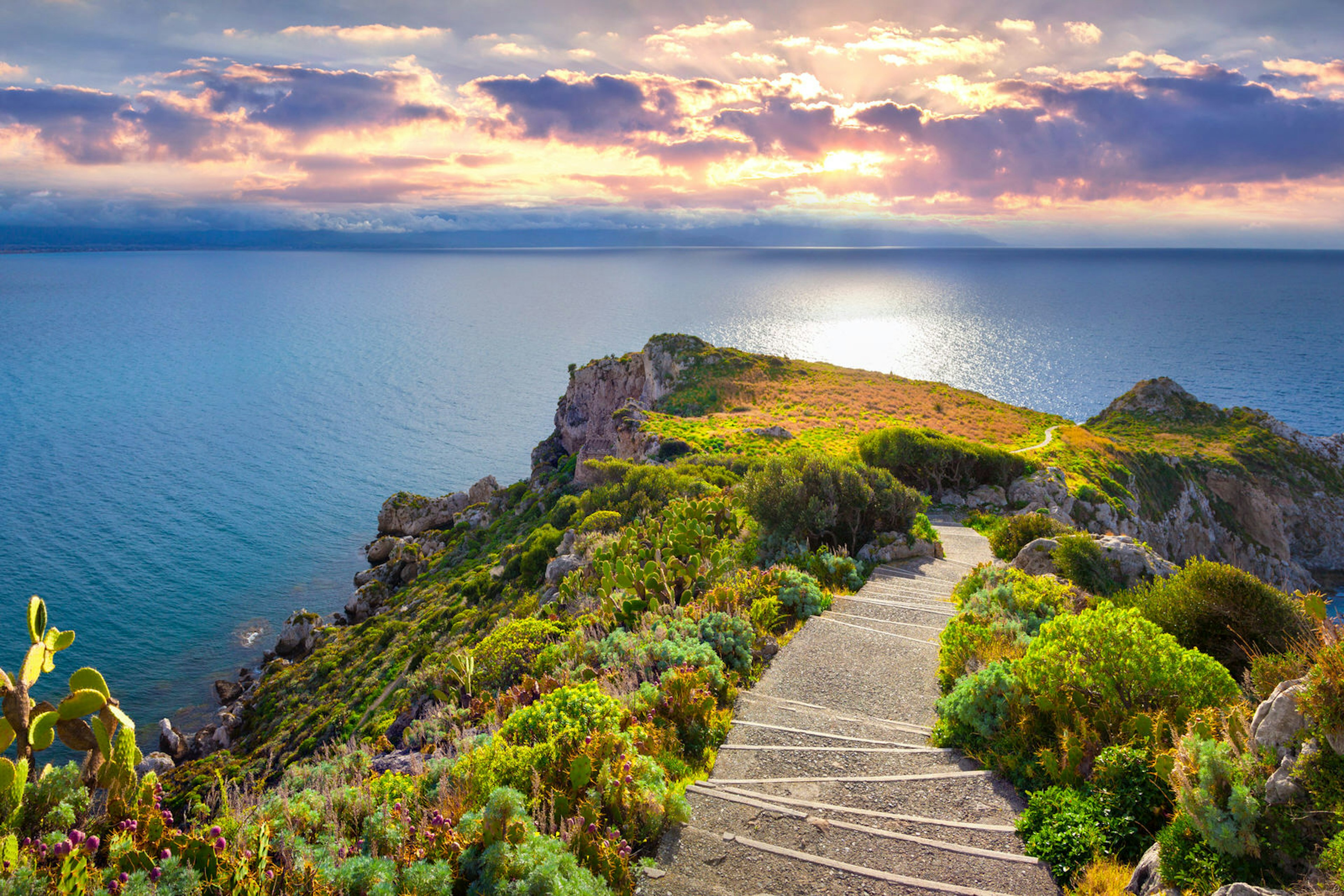 Descending towards the tip of Capo Milazzo at sunset