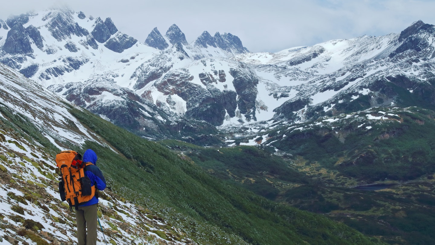 A lone hiker on the remote Dientes de Navarino Circuit on Isla Navarino in South Chile. The trail is one of the most remote in Patagonia.