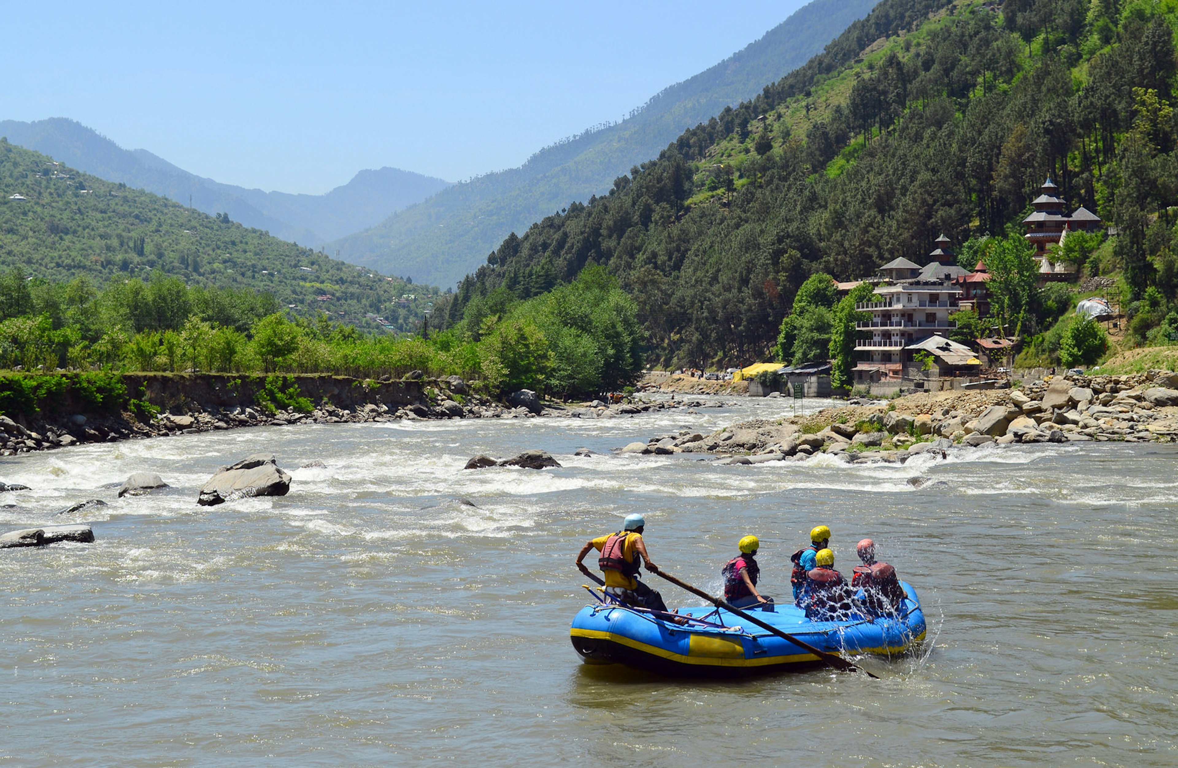 Whitewater rafters glide towards rapids in Himachal Pradesh