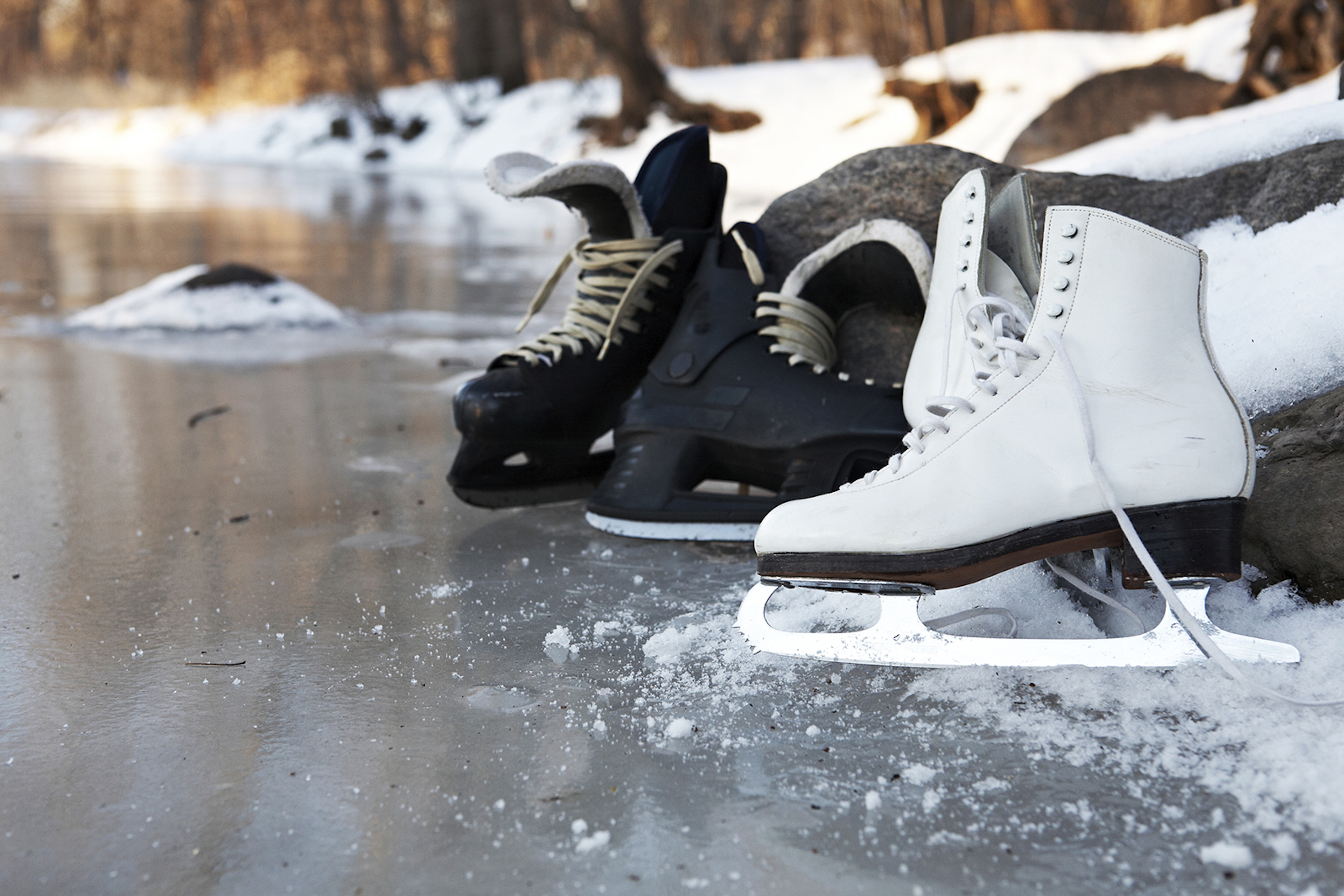 Hockey skates and figure skates together on a frozen pond in winter in Minneapolis