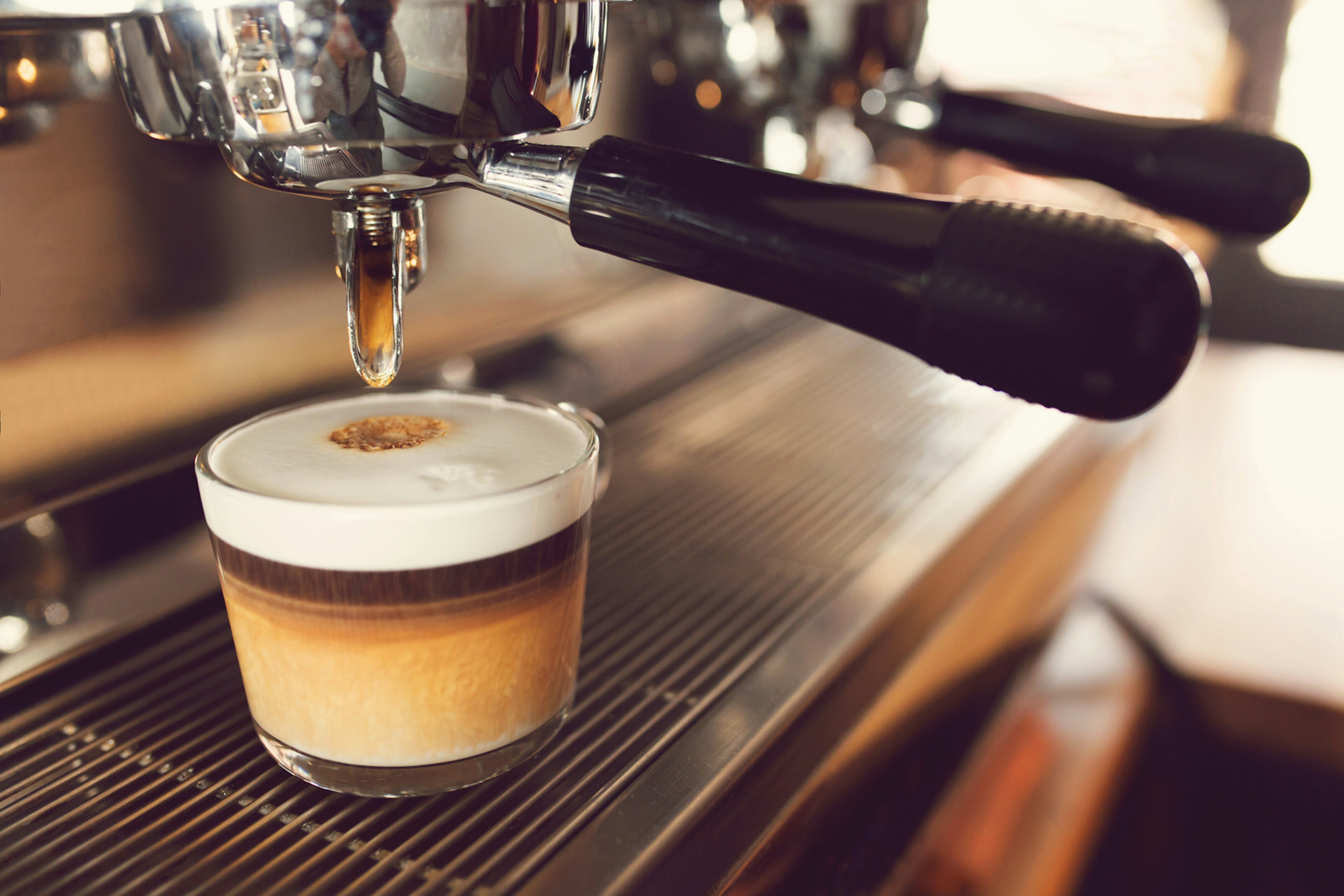 Close up of a marocchino - a mix of coffee, cocoa powder and milk - being made by a coffee machine