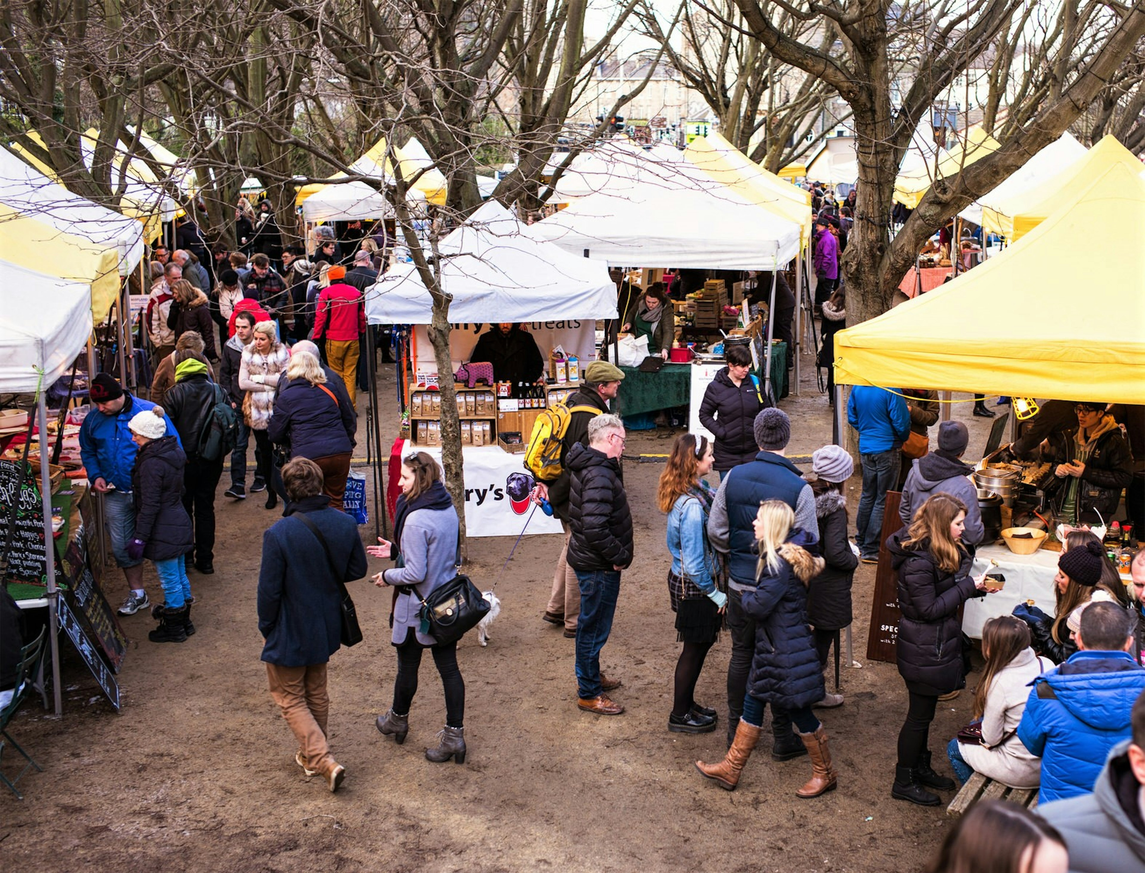 People walk around stalls at Stockbridge Farmers' Market.