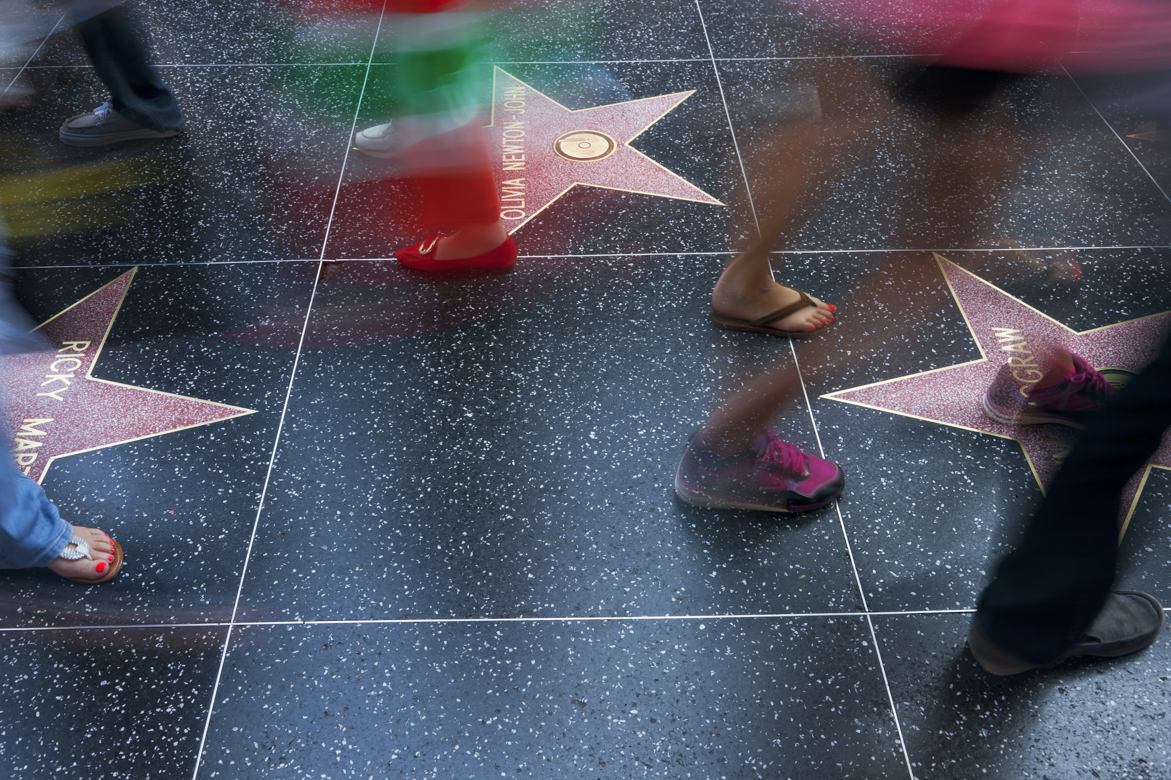 Long exposure of legs walking over the Hollywood Walk of Fame