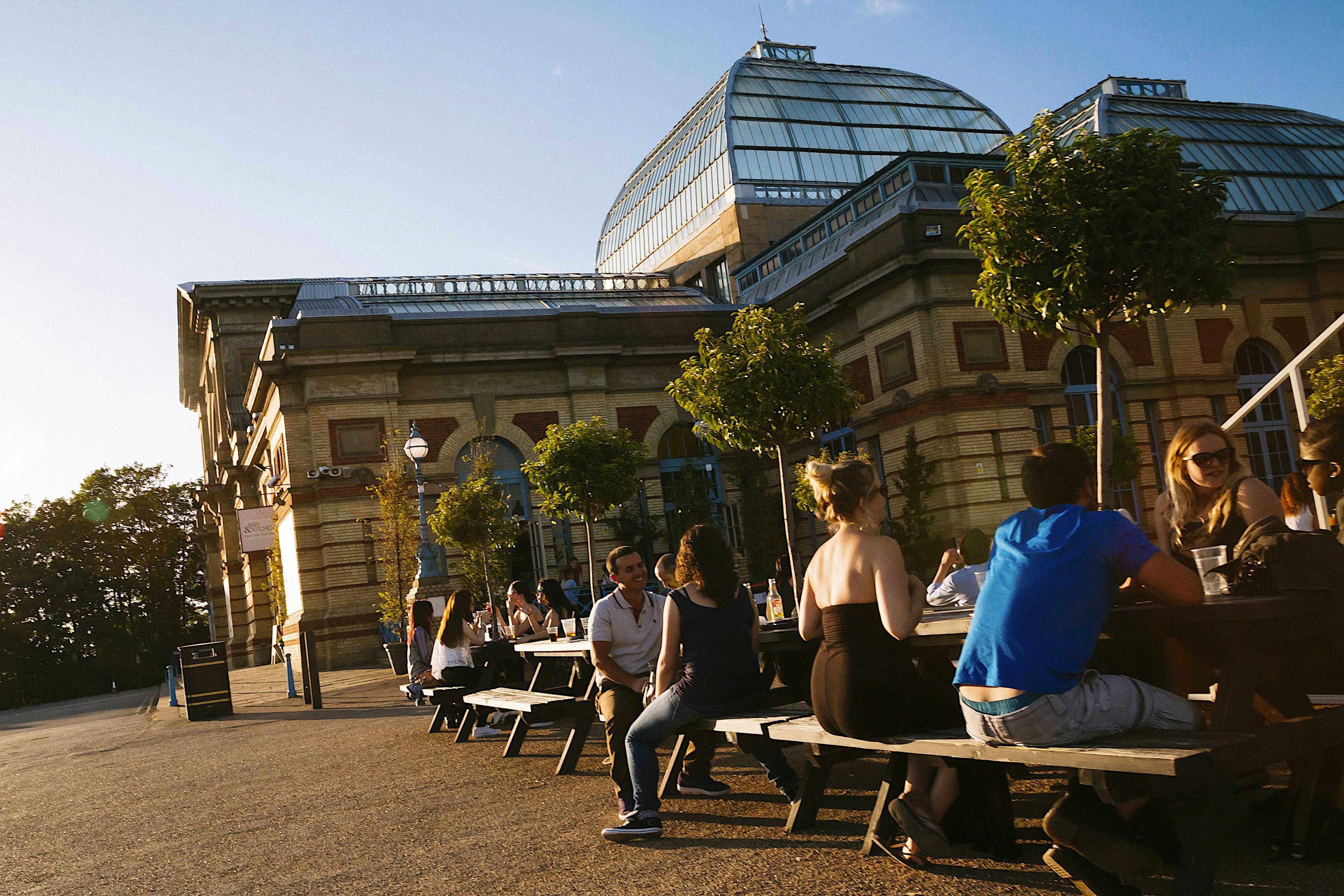 People sitting on benches next to Alexandra Palace