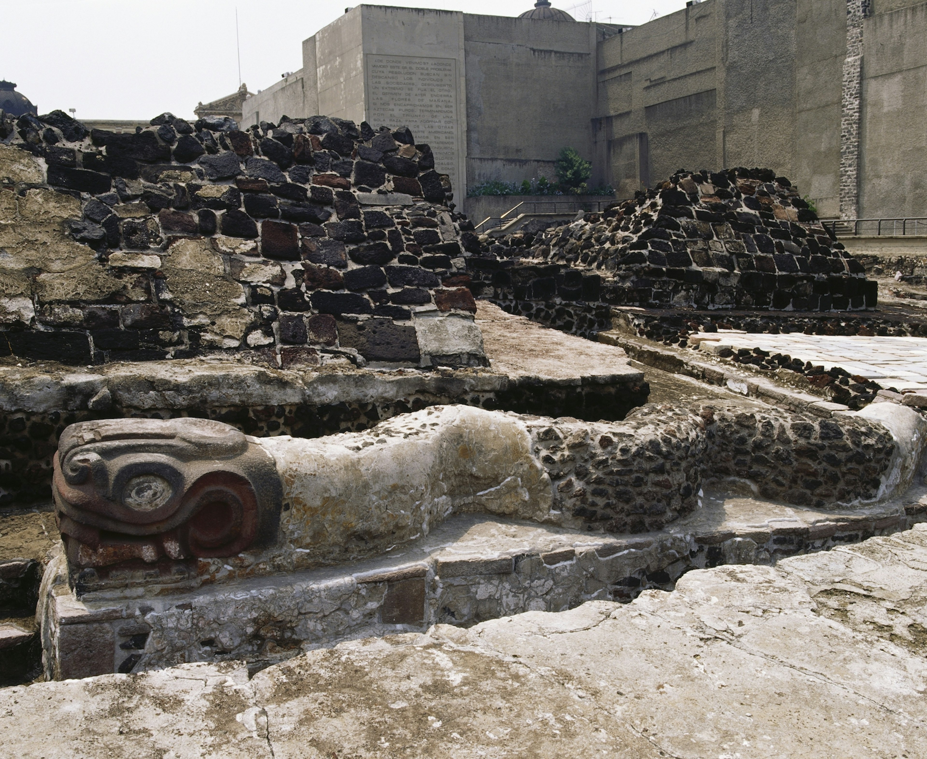 A giant stone snake in the midst of Aztec ruins