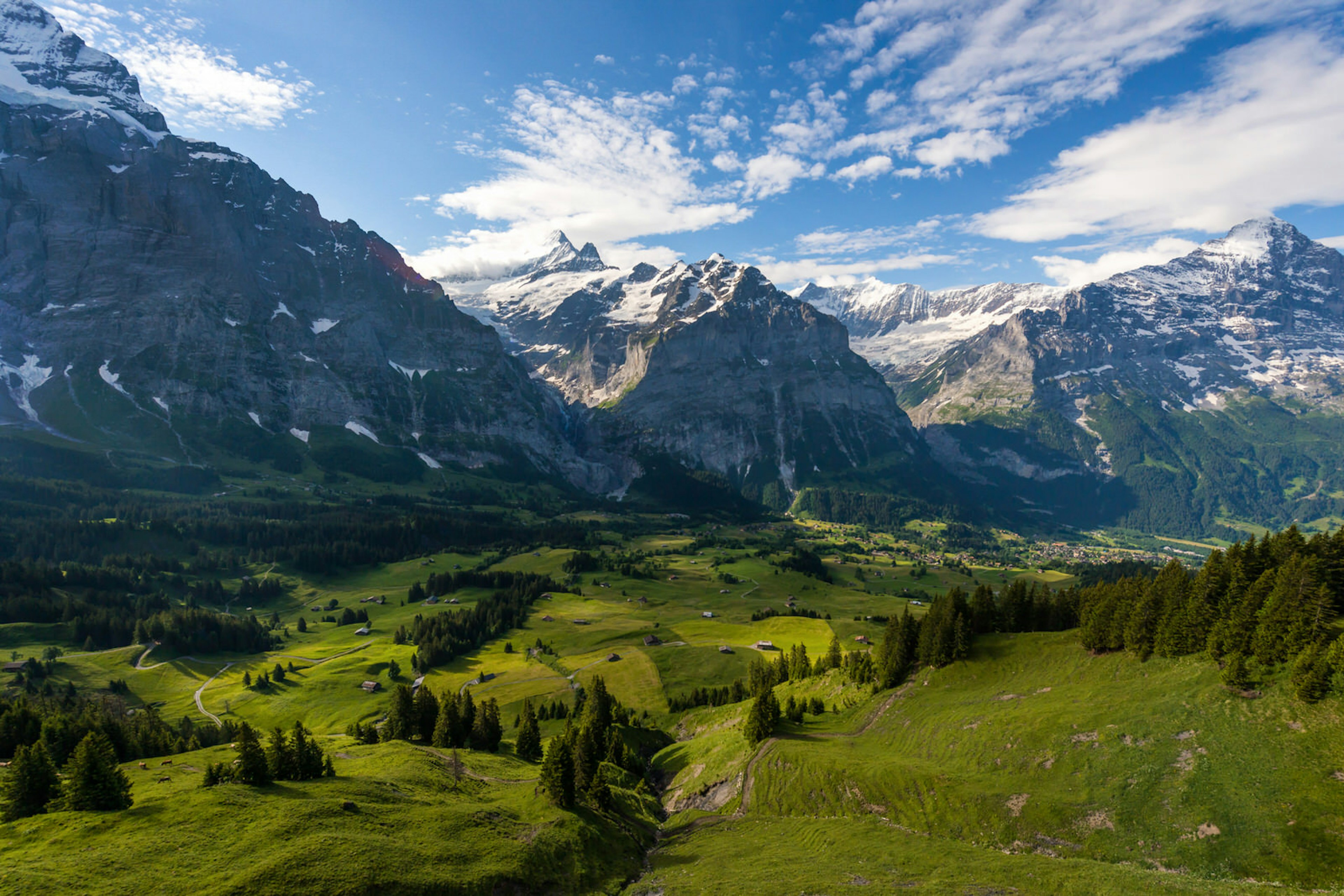 Snow-capped mountains frame a verdant valley