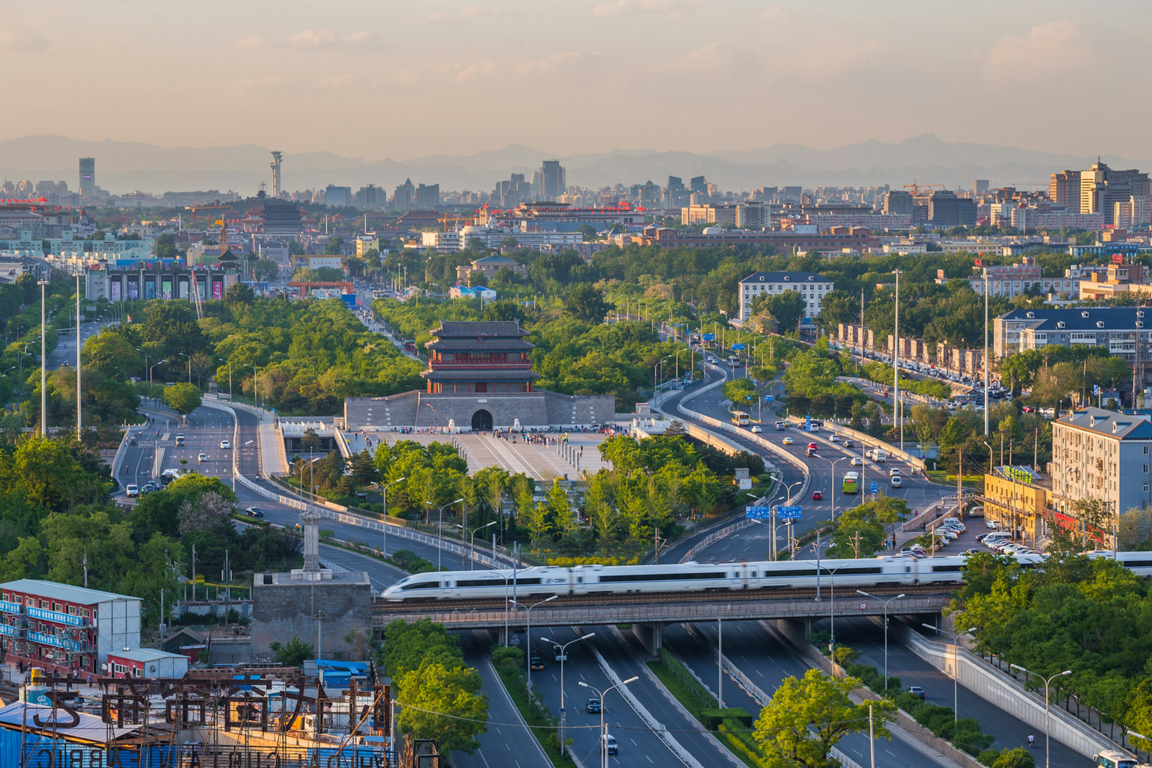 A high-speed train passes Beijing's Yongding Gate before zipping passengers across the country © ViewStock / Getty