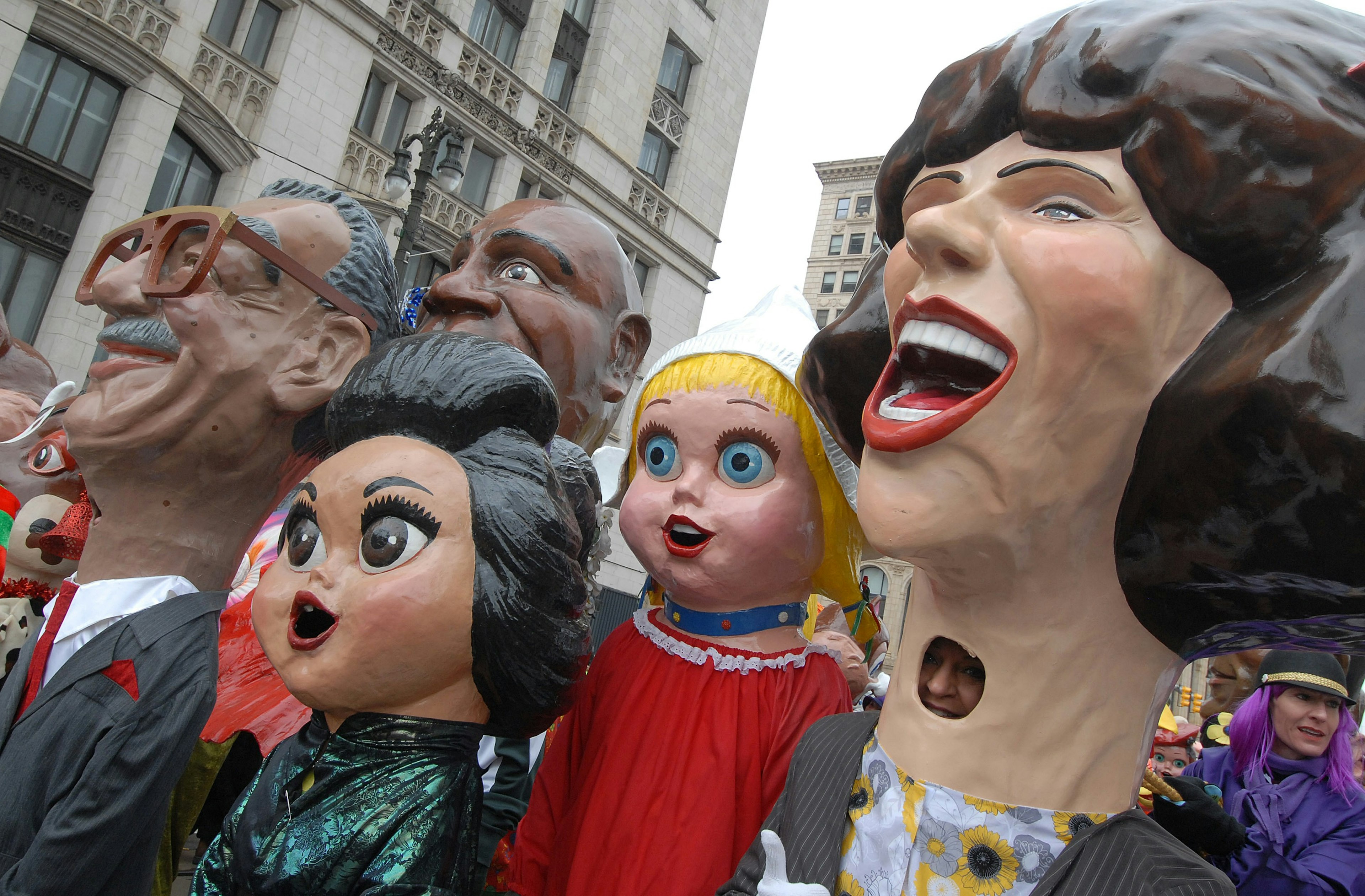 Big Head Corps members pose on Woodward Ave in Detroit during the America's Thanksgiving Day Parade.