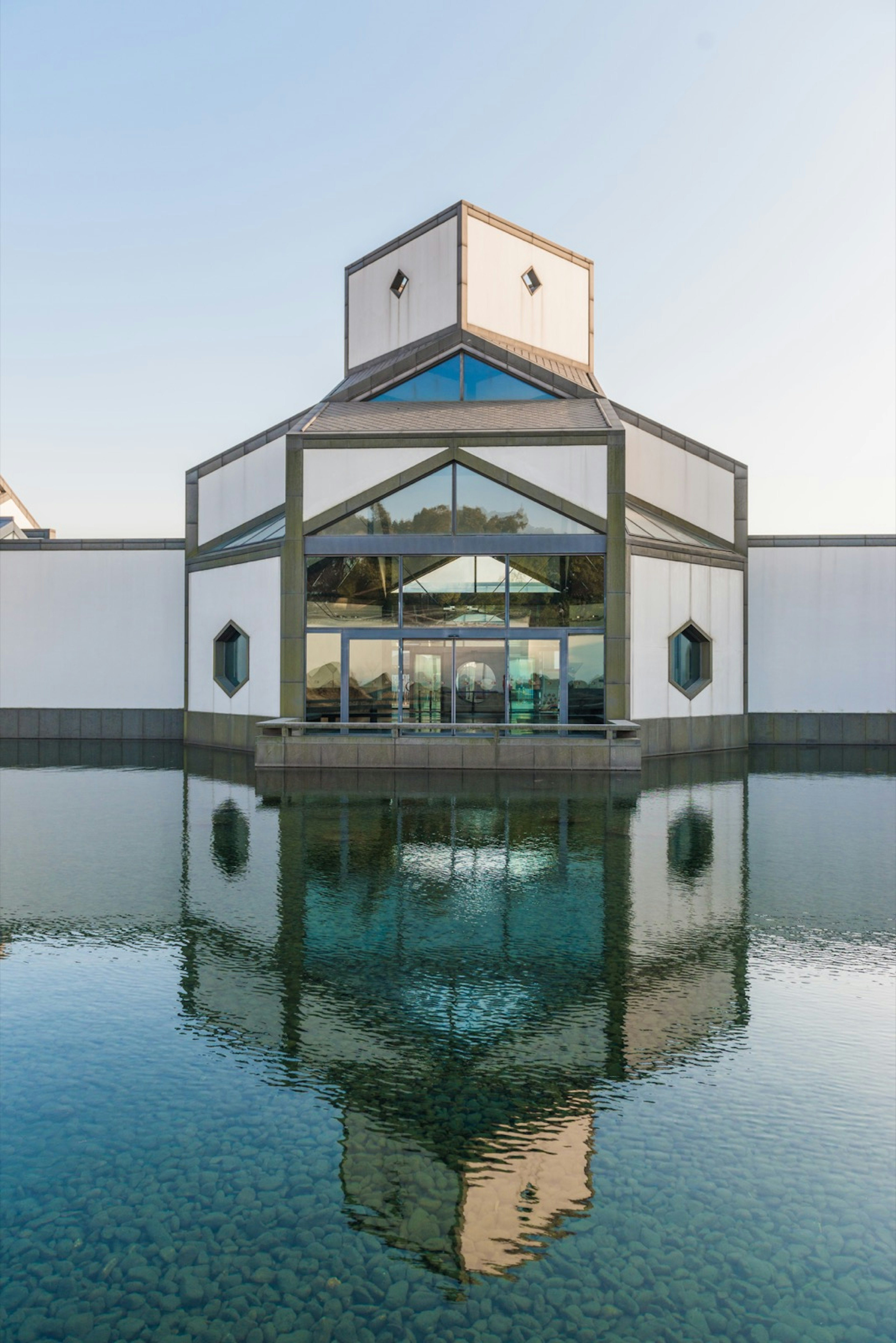 The facade of the museum is reflected perfectly in the water below