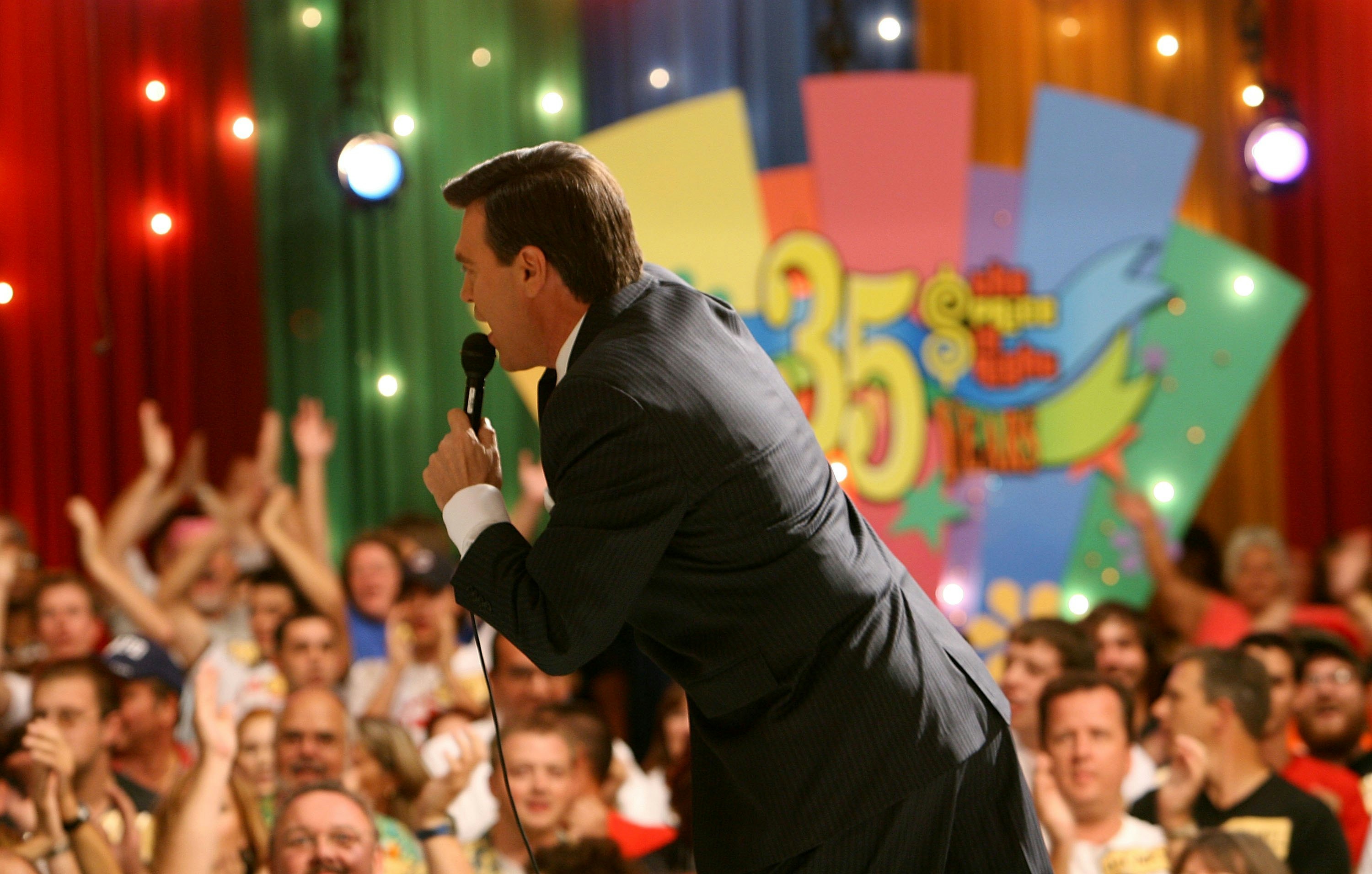 Announcer Rich Fields speaks to the audience before the taping of the 35th Season premiere of