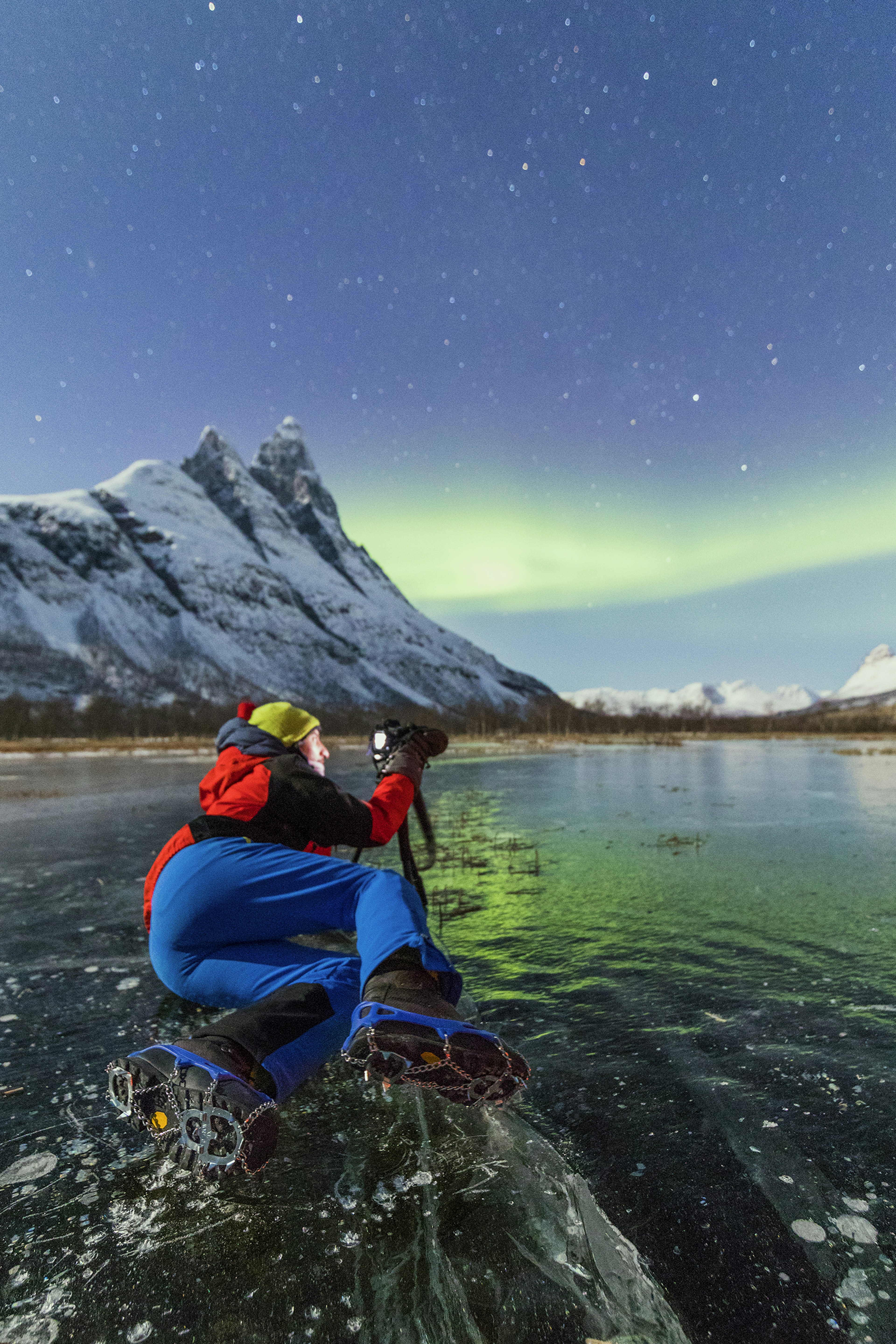 Photographer taking picture of Northern Lights near Tromsø