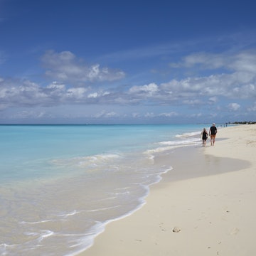 People walking along the sand of Grace Bay, on Providenciales, Turks and Caicos.
At 12 miles, 19 km, long Grace Bay is reckoned to be one of the longest and most spectacular beaches in the Caribbean. Nigel Hicks/Getty Images