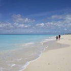 People walking along the sand of Grace Bay, on Providenciales, Turks and Caicos.
At 12 miles, 19 km, long Grace Bay is reckoned to be one of the longest and most spectacular beaches in the Caribbean. Nigel Hicks/Getty Images