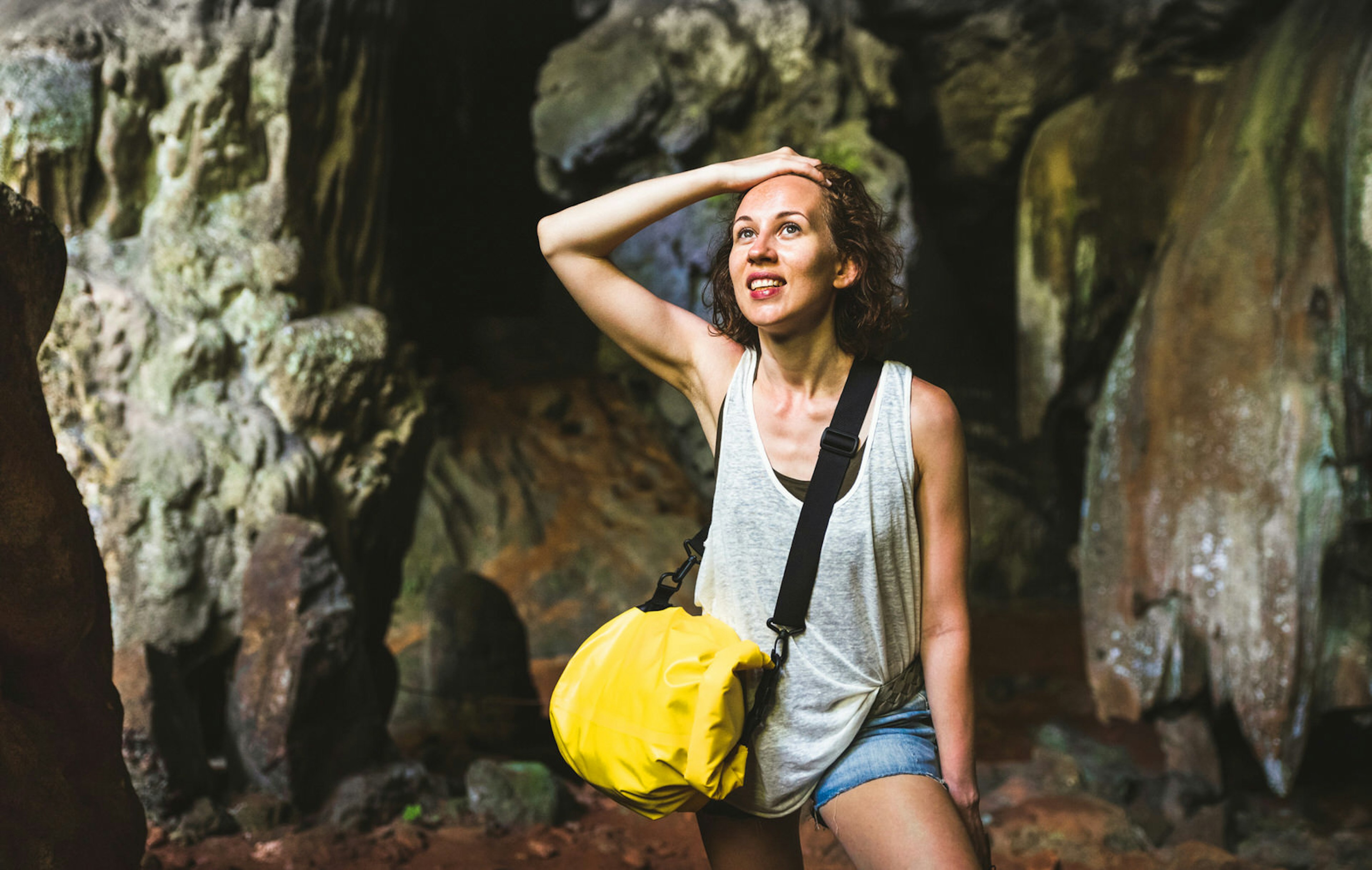 A young woman takes in the sights of cave formations in Khao Sok © ViewApart / Getty Images