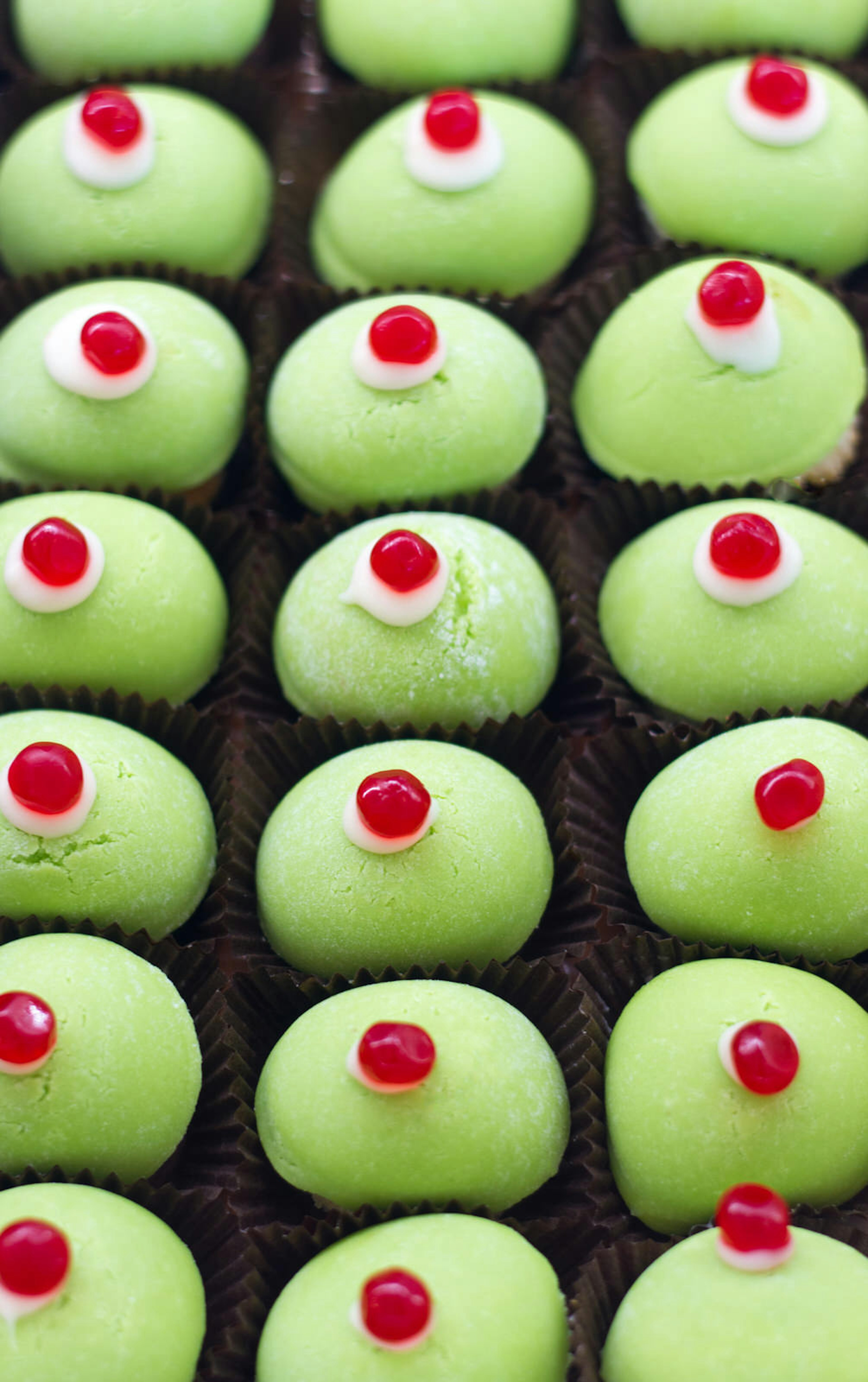 Green minni di virgini (virgin's breasts) pastries with cherries on top