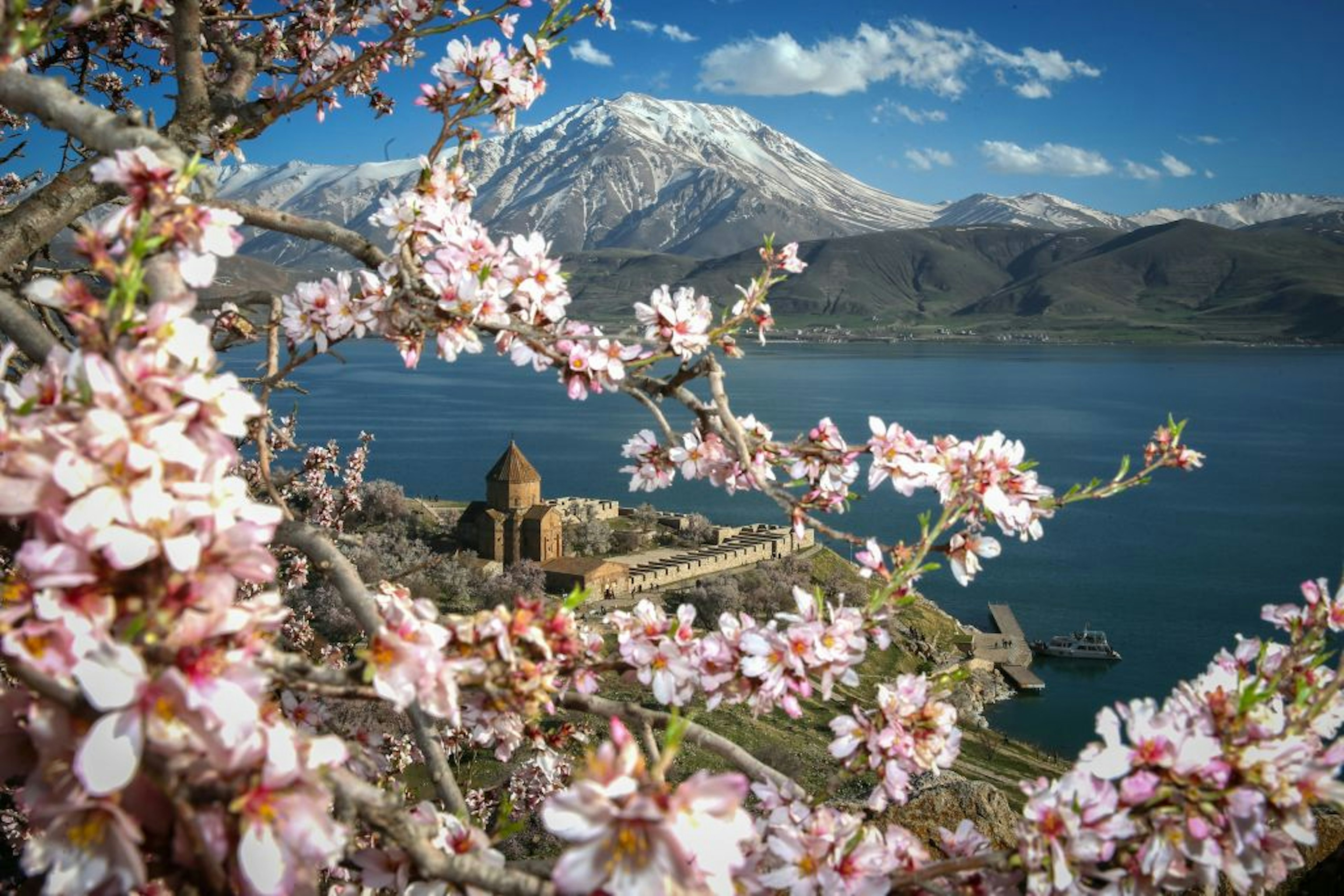 VAN, TURKEY - MARCH 26: Historical Akdamar church is seen enclosed with trees in blossom at Akdamar island in Lake Van. Image: Ozkan Bilgin/Anadolu Agency/Getty Images