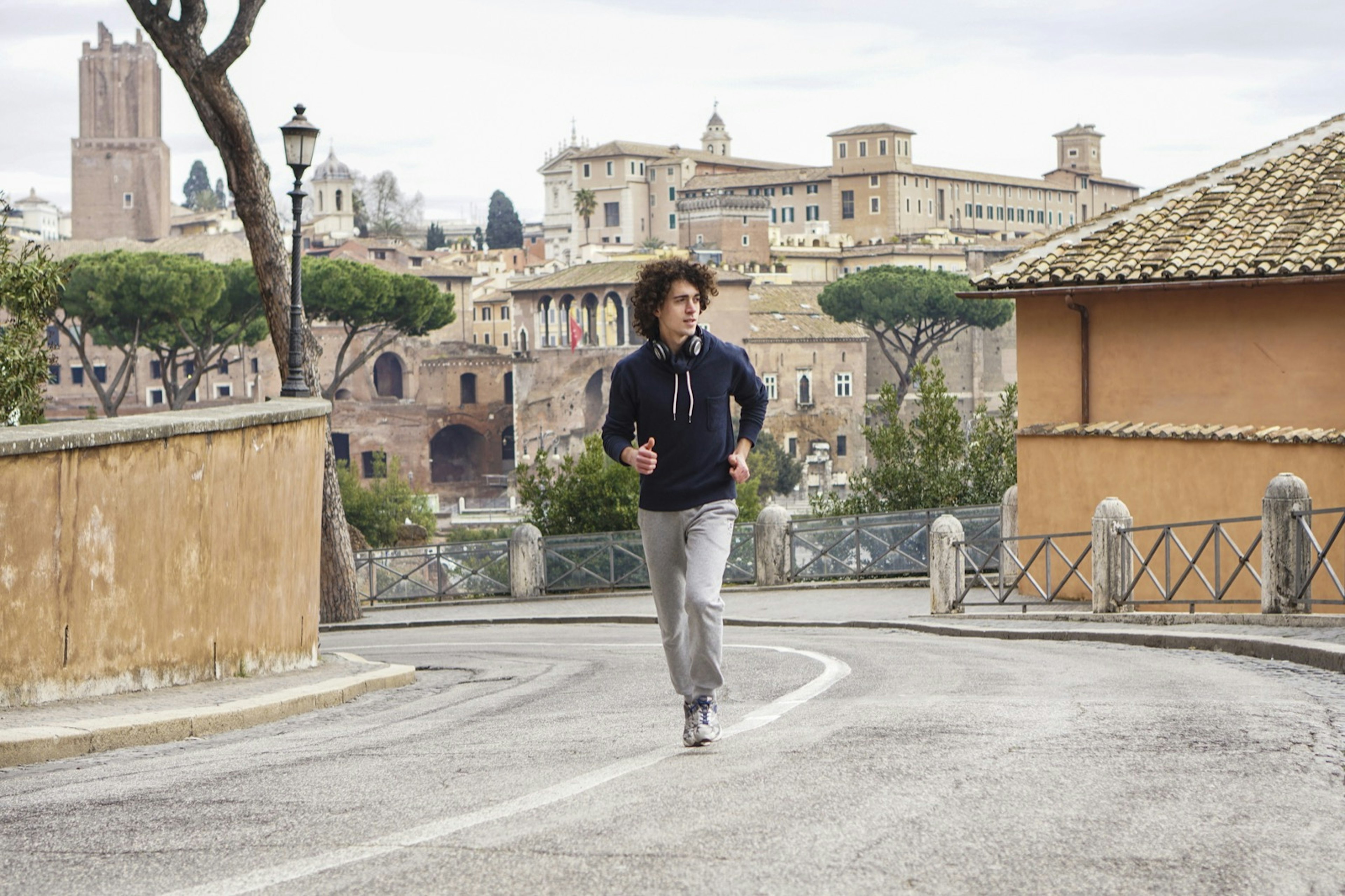 A man jogs up a small hill in Rome; sacred space