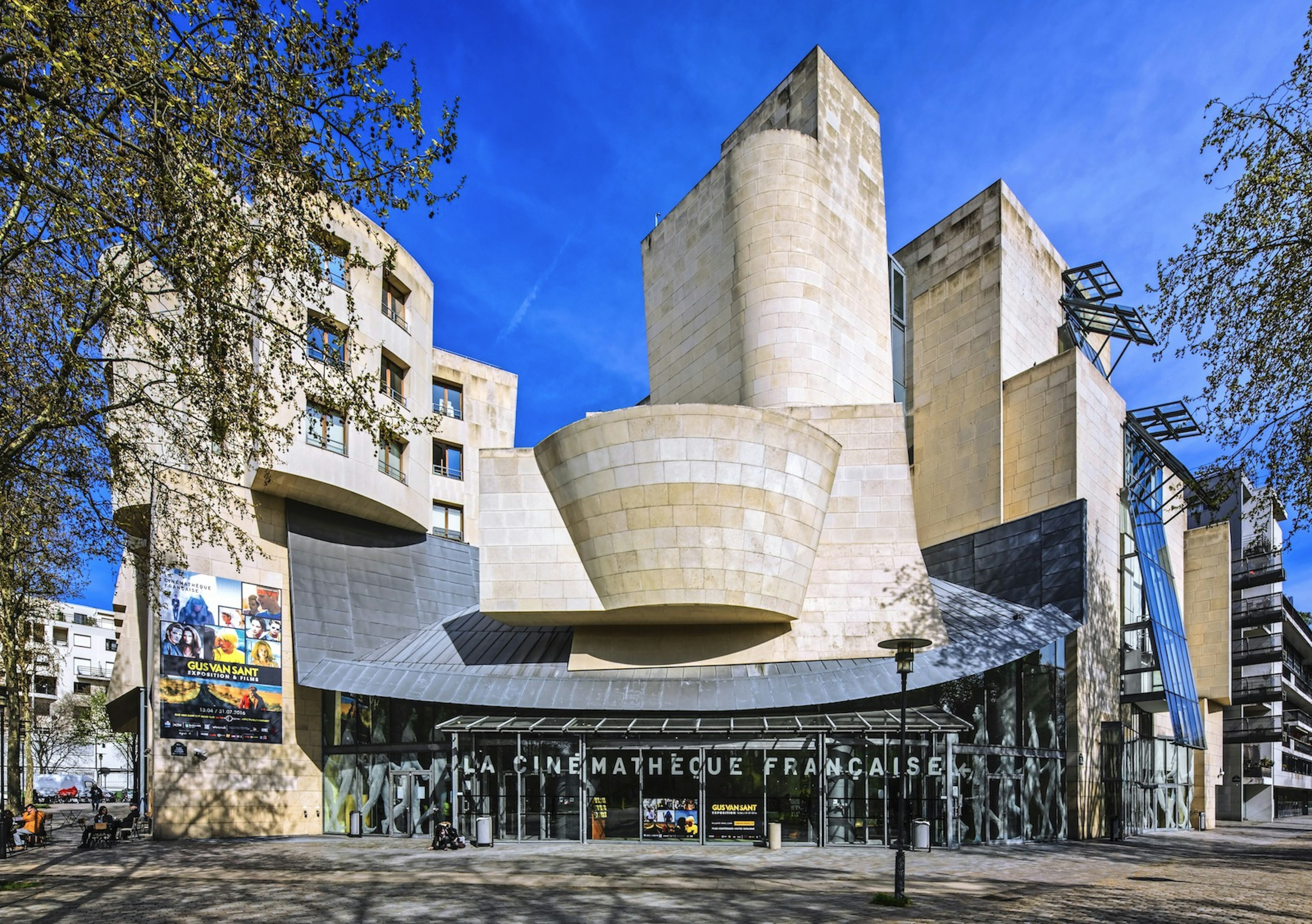 La Cinémathèque çe in Paris, a uniquely shaped building framing a blue sky background