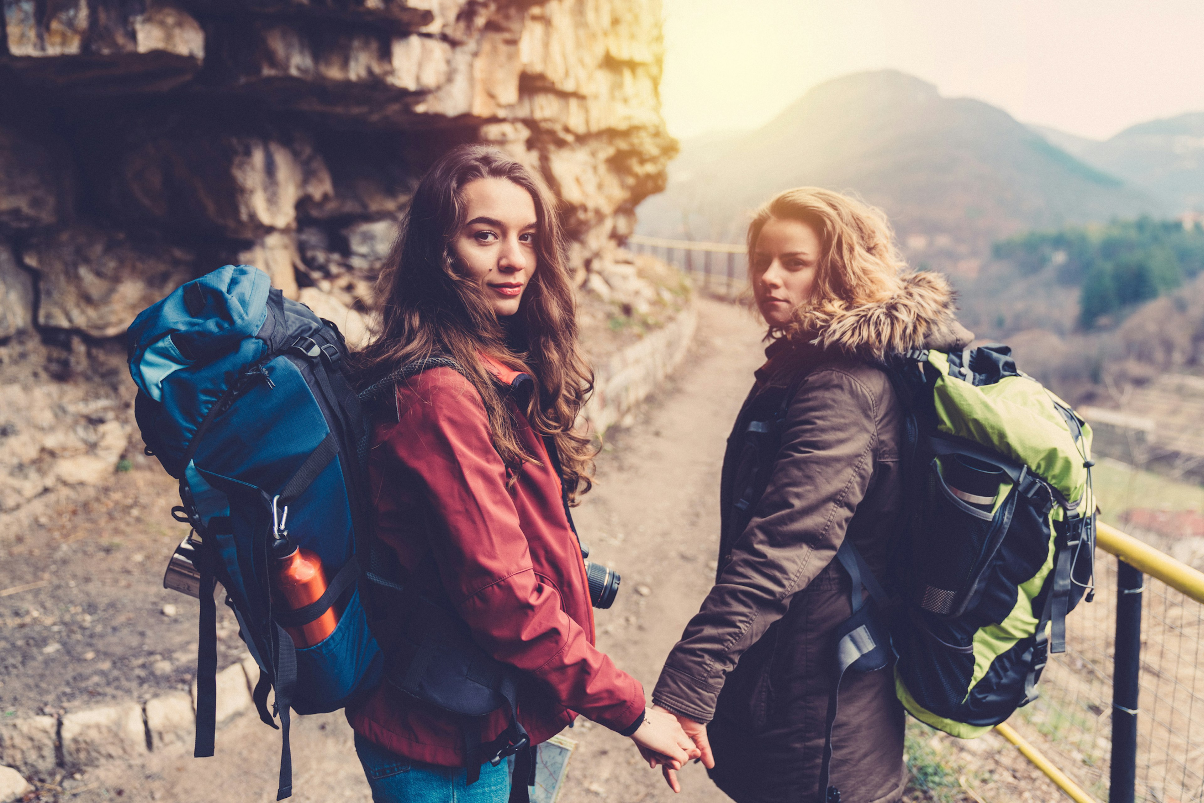 Couple backpacking in the mountains holding hands