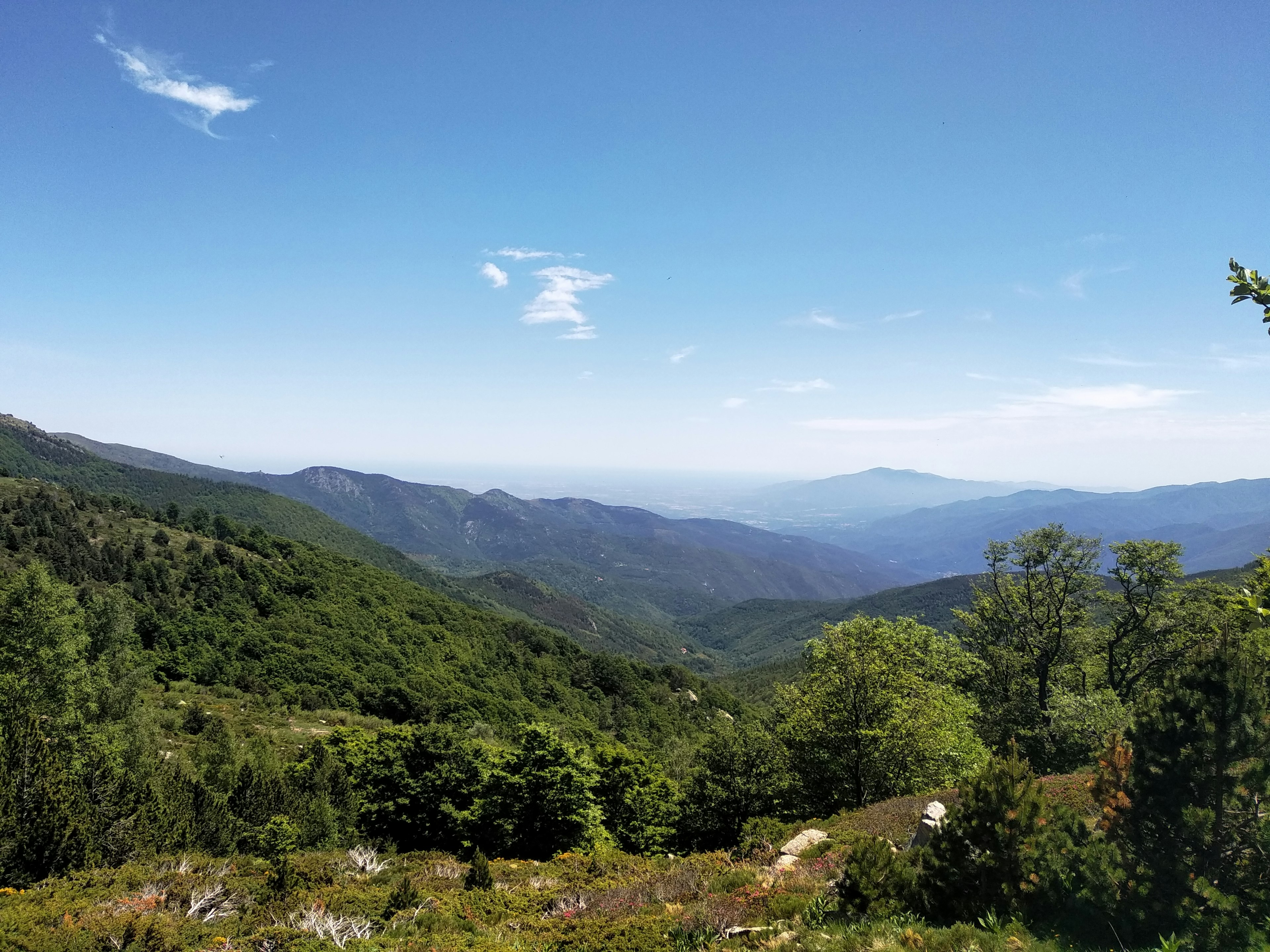 Green mountains under a blue sky.