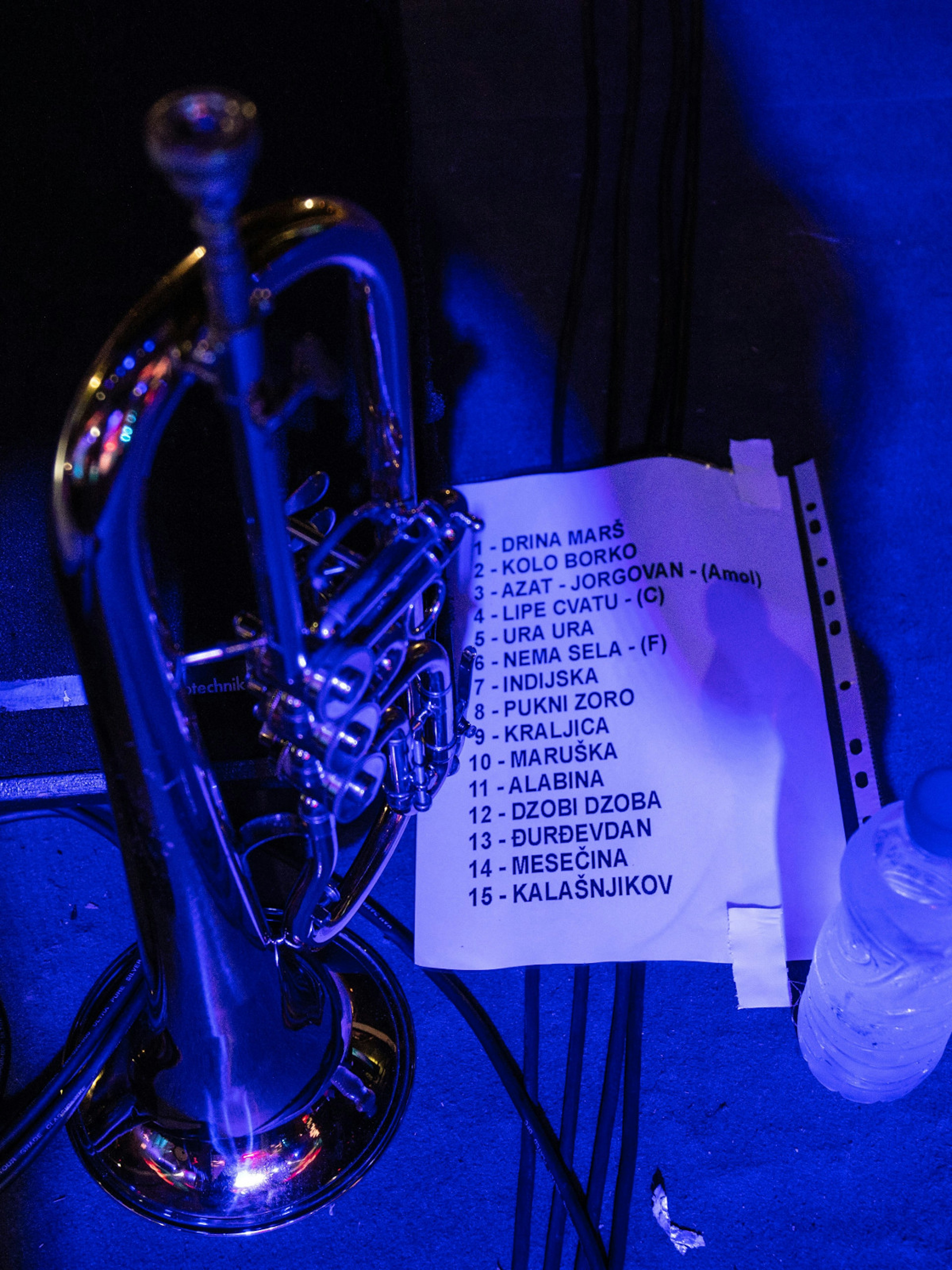 A playlist taped to the stage floor, next to a trumpet, featuring popular songs for a concert at the Guča Trumpet Festival  © Aleksandar Donev / Lonely Planet