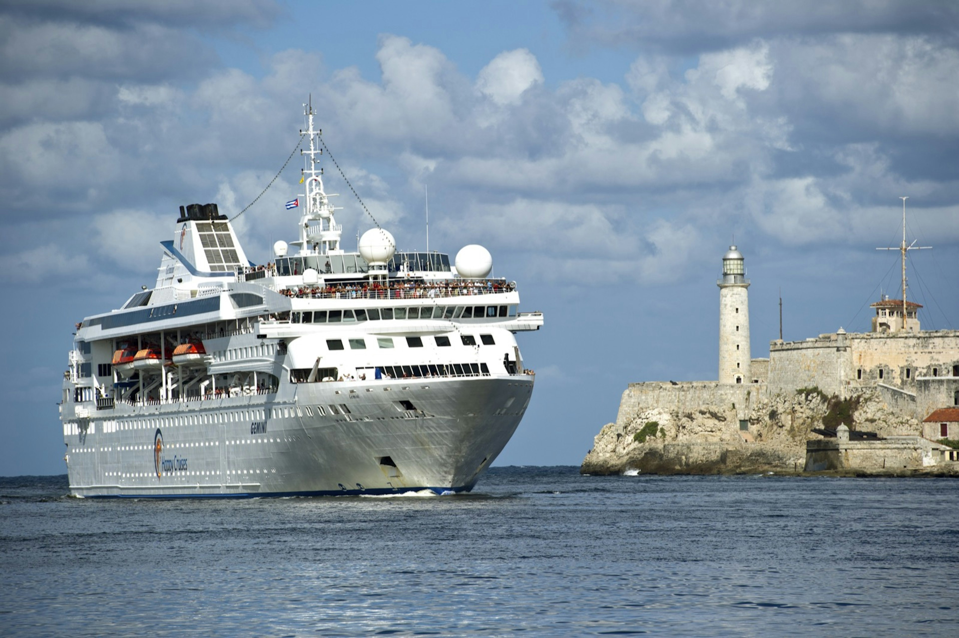 A large cruise ship sails past a lighthouse into the Havana harbor. A new Trump policy has restricted cruise lines from visiting Cuba.