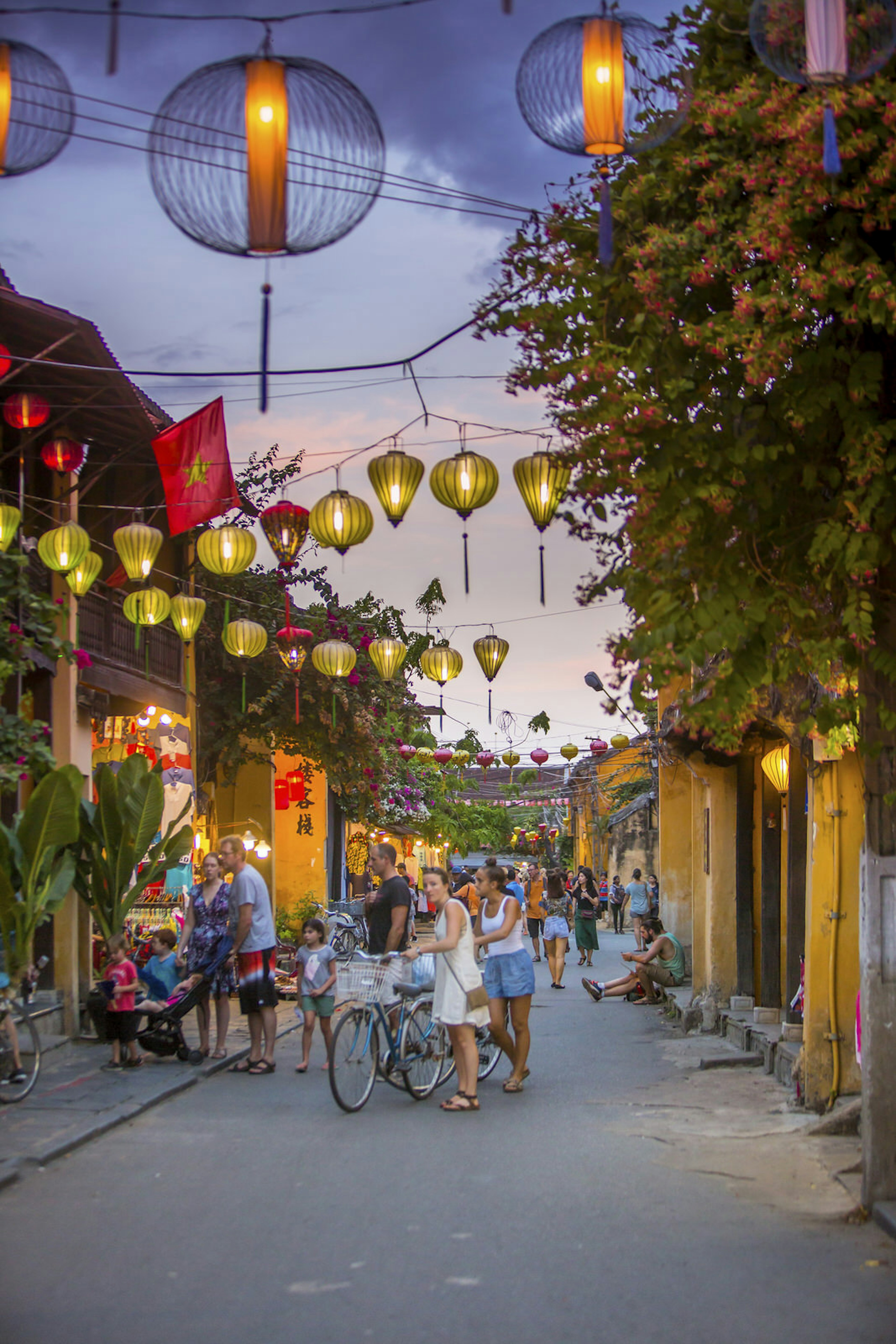 June 2017 Hoi An, Vietnam - Tourists walk down the colonial streets in historic old town Hoi An. Lanterns illuminate the walkways.