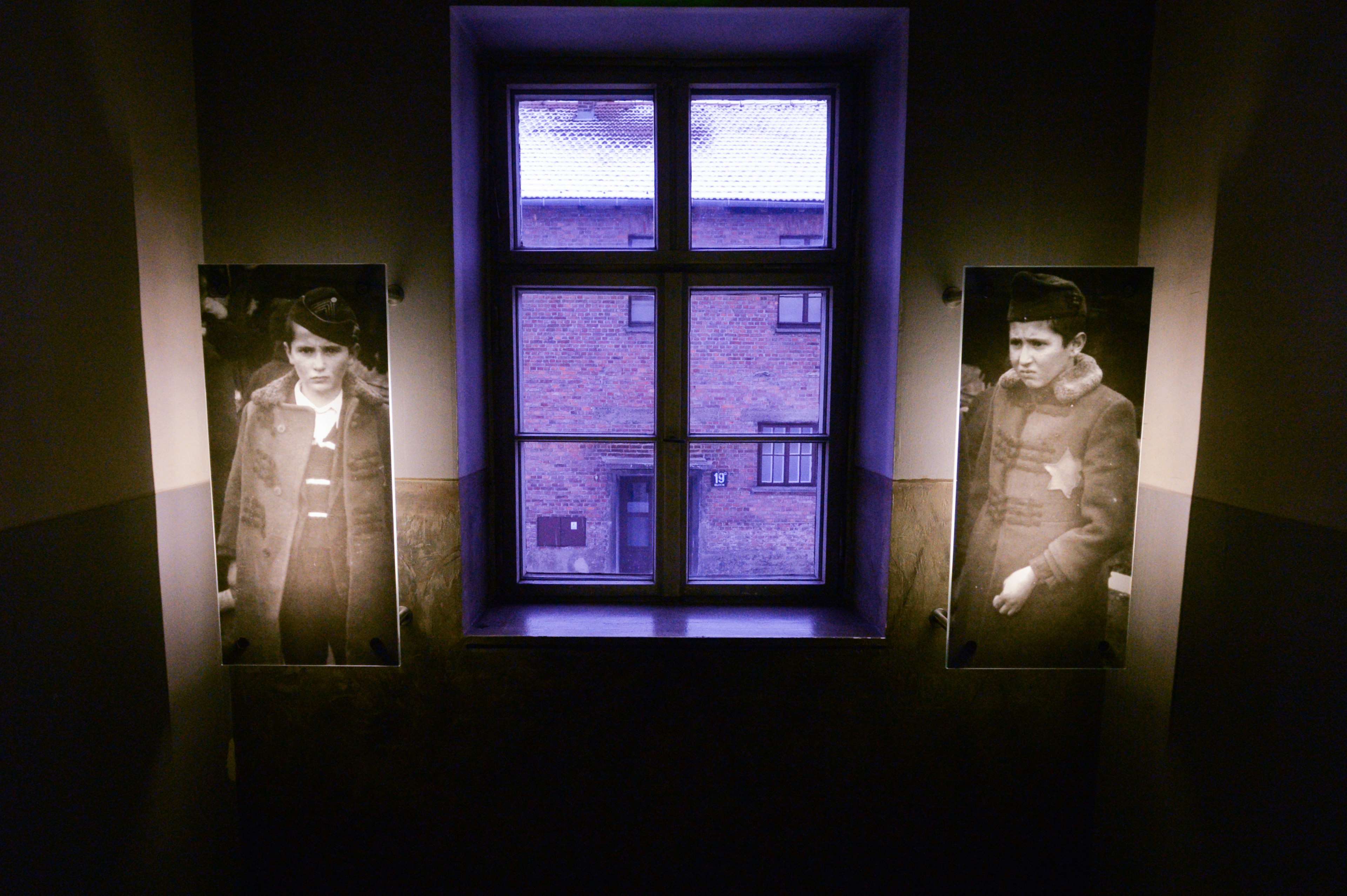 Two photos of young men hang in the holocaust museum