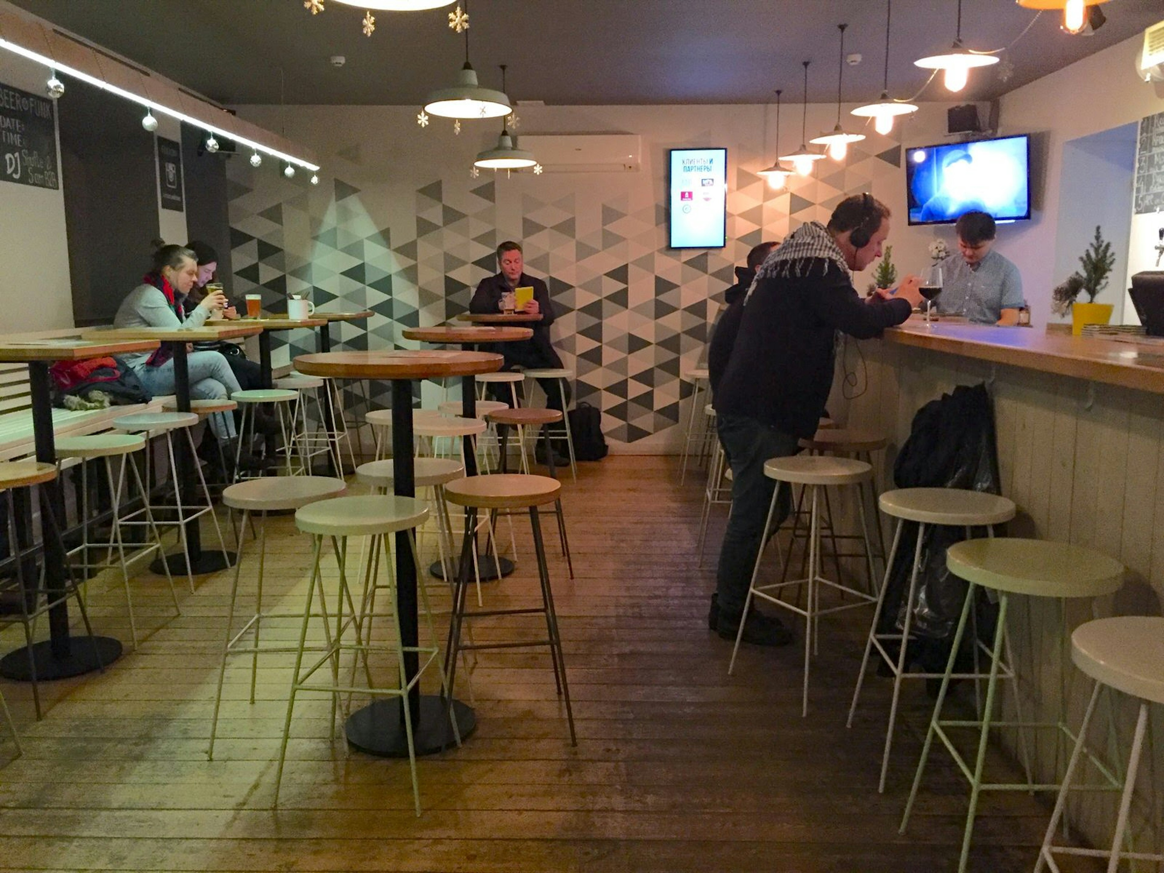 High tables and stools in a sleek, minimalist taproom at Rockets & Bishops in St Petersburg © Megan Eaves / Lonely Planet