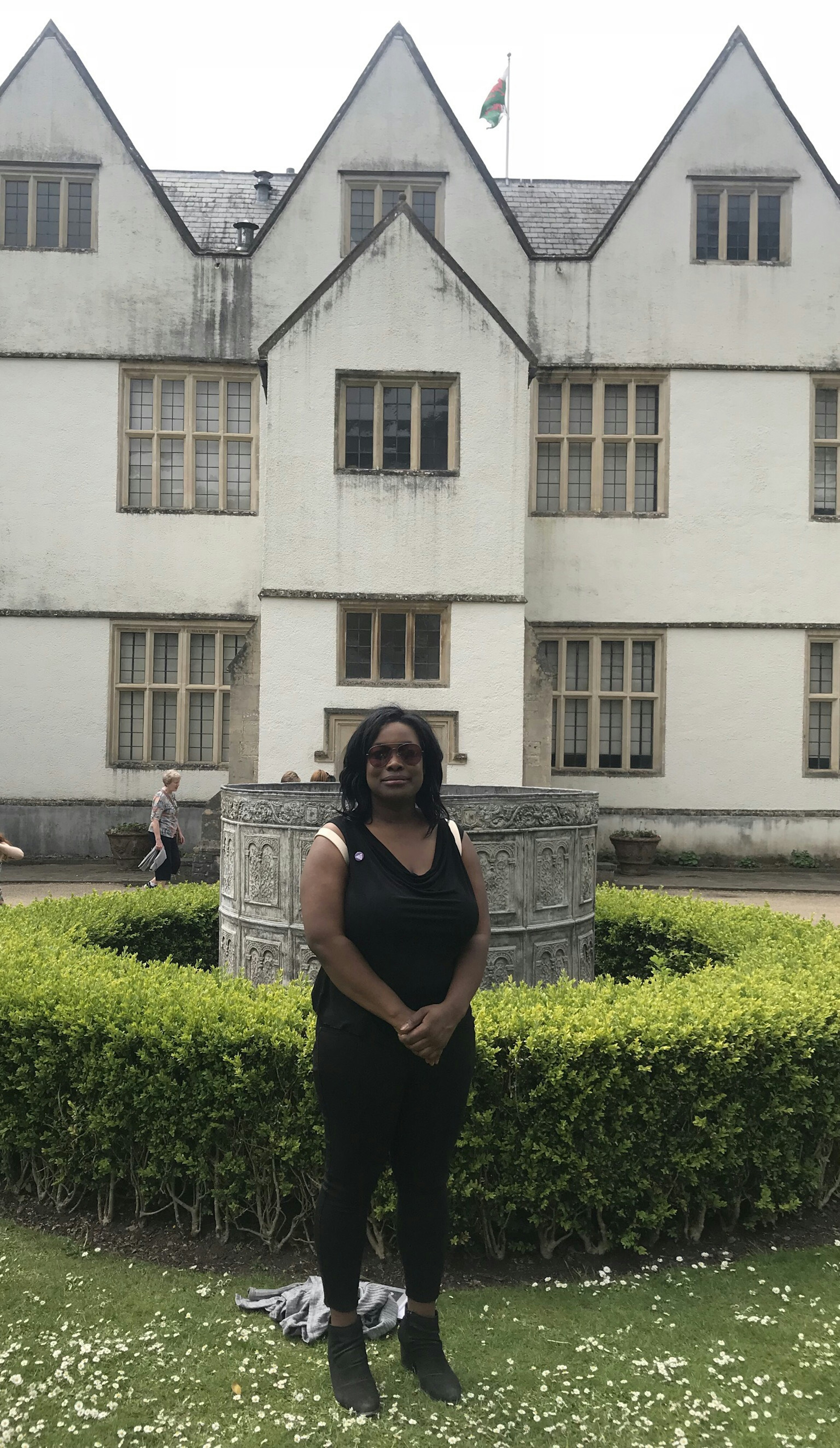 An African American woman stands in the garden at St. Fagan's National Museum of History in Wales.