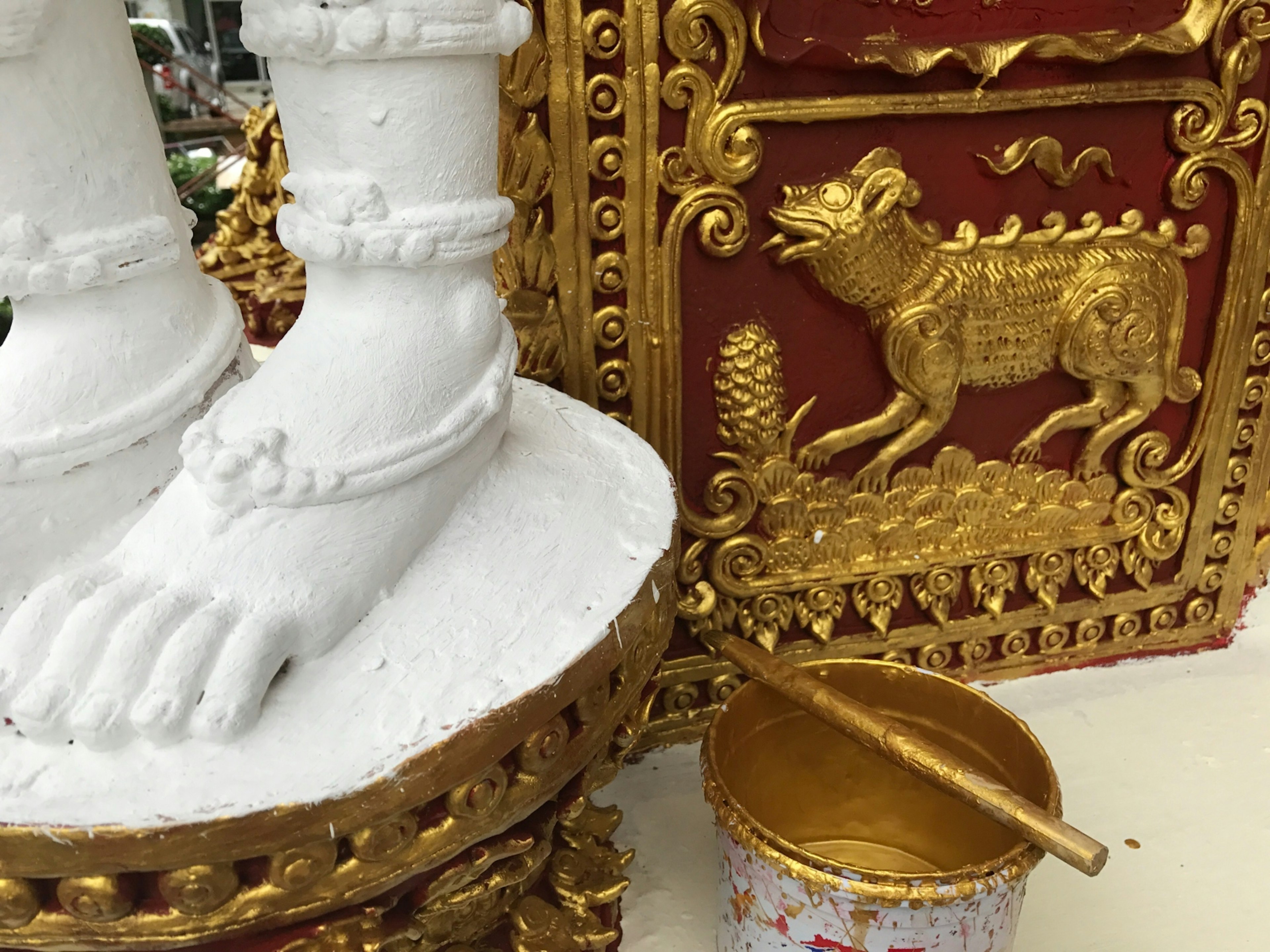 A Buddha statue's feet are painted gold at a temple in Chiang Mai © Celeste Brash / Lonely Planet